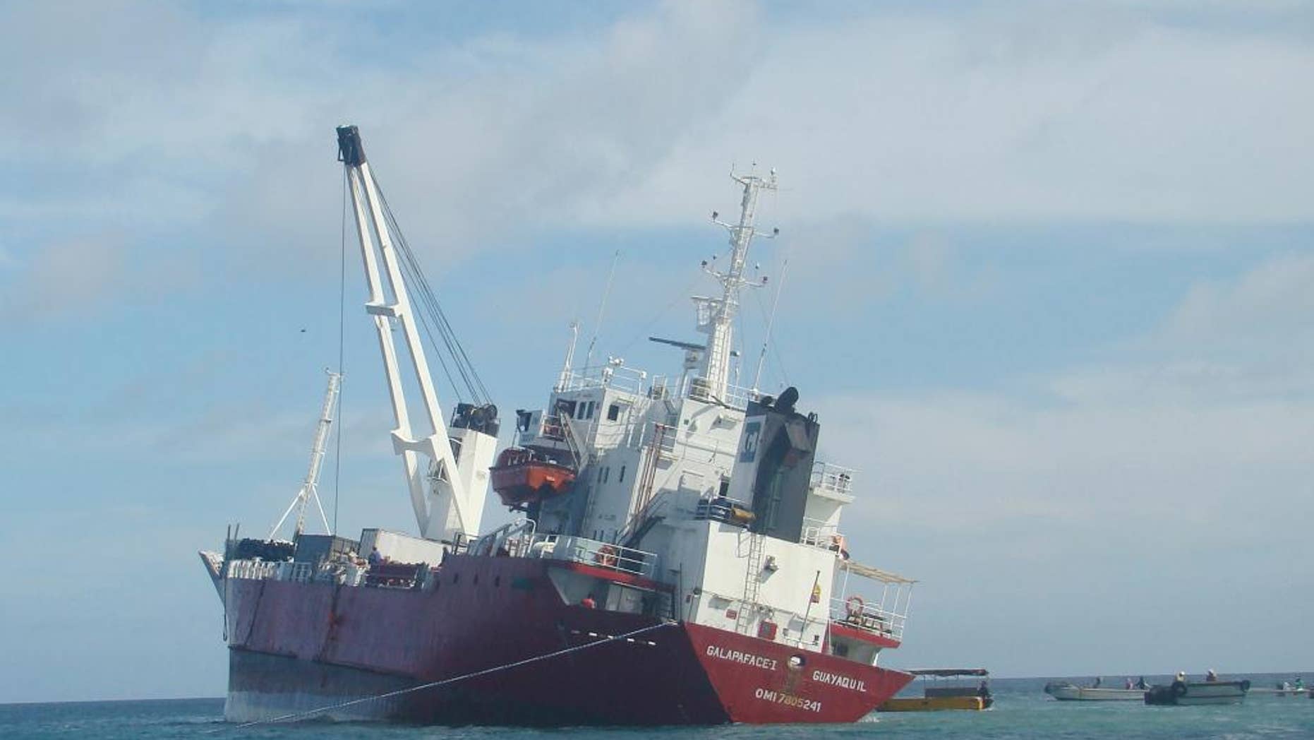 This Friday, May 9, 2014 photo, released by Galapagos National Park, shows the freighter Galapaface I that ran aground in the bay adjacent to San Cristobal island, in the Galapagos Islands. Ecuadorean authorities said Friday, May 16, 2014, they have offloaded all the fuel and most of the cargo from the freighter, and it will take three to four weeks to refloat and rescue the ship. (AP Photo/Galapagos National Park)