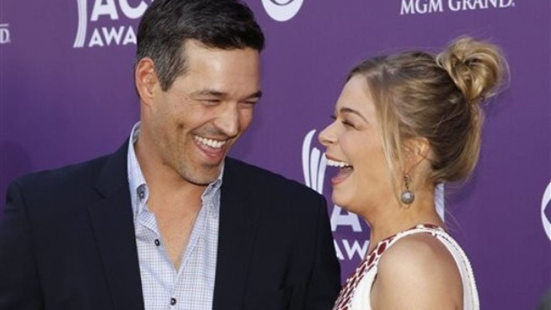 LeAnn Rimes, right, and Eddie Cibrian arrive at the 47th Annual Academy of Country Music Awards on Sunday, April 1, 2012 in Las Vegas. (AP Photo/Isaac Brekken)