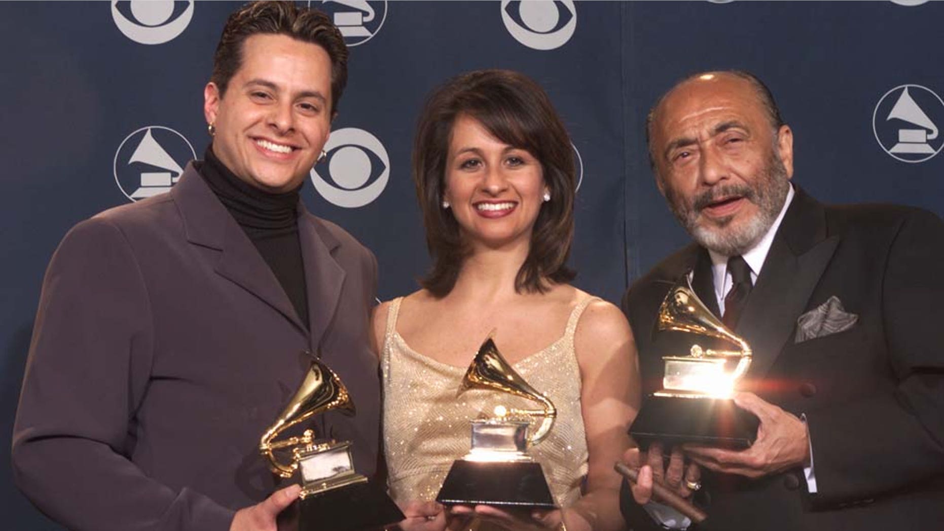 Tito Puente Jr.(left), sister Audrey, and Eddie Palmieri pose with Grammys for Best Salsa Album backstage at the 43rd Annual Grammy Awards at Staples Center in Los Angeles Wednesday, Feb. 21, 2001.