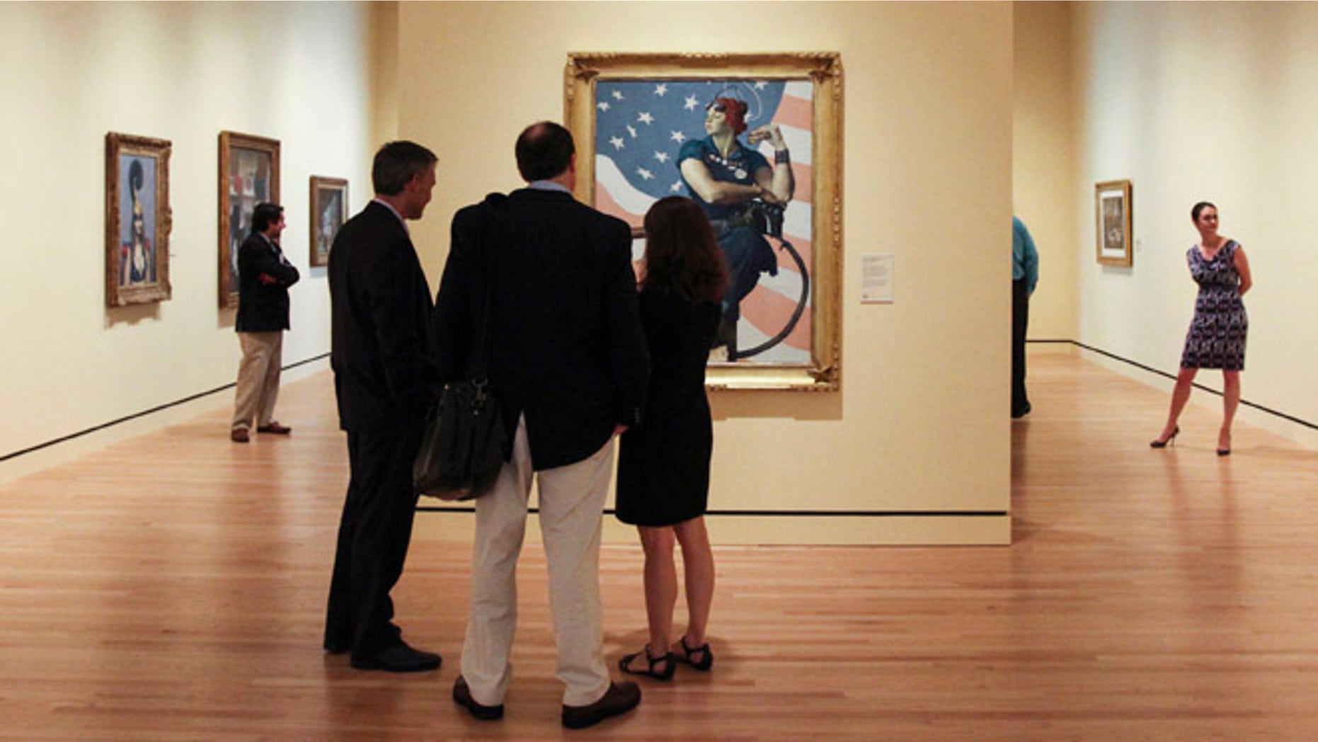 FILE 2012: Guests observe Norman Rockwell's 1943 oil on canvas painting "Rosie the Riveter" in Bentonville, Arkansas.