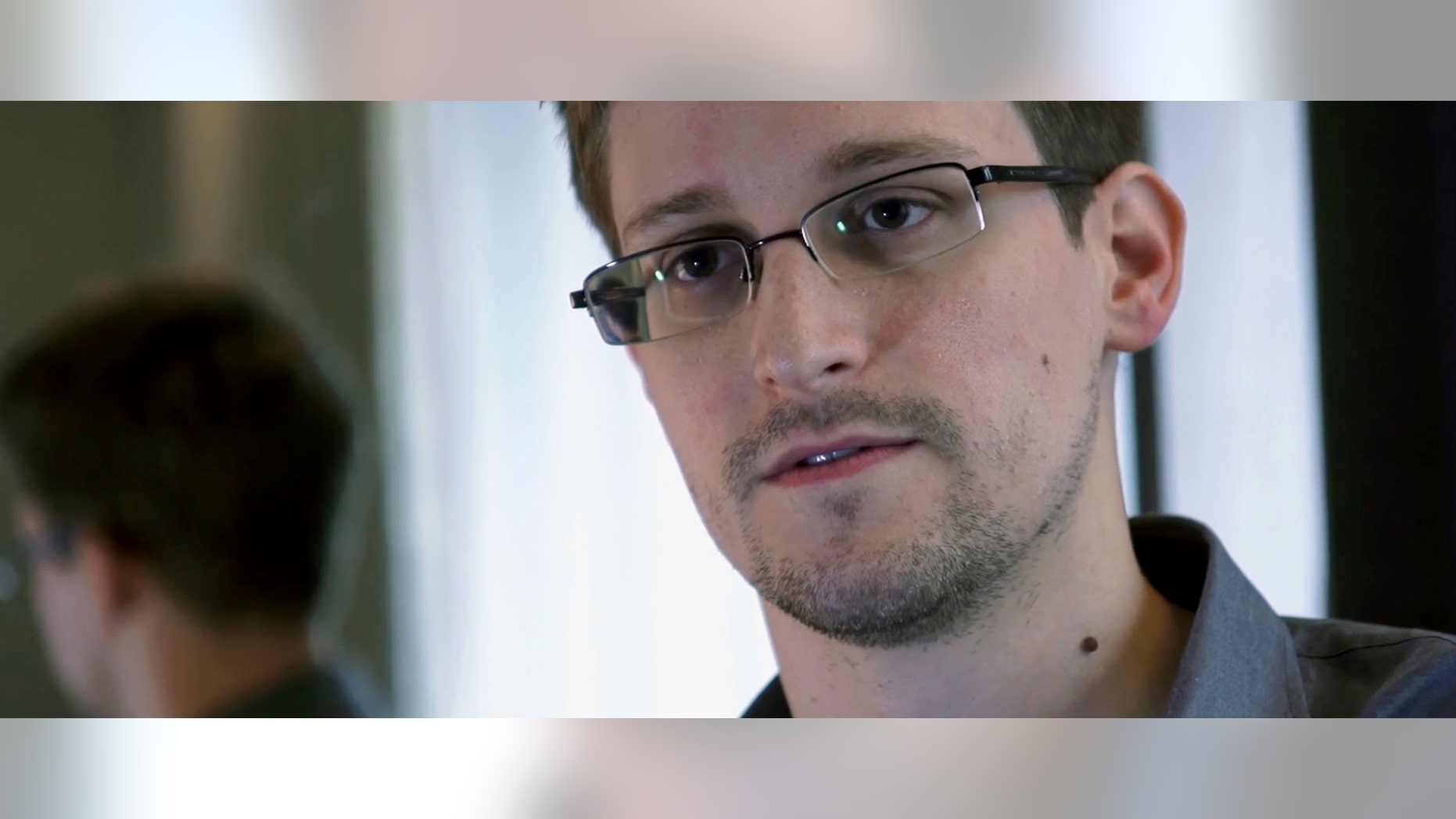FILE -- This photo provided by The Guardian Newspaper in London shows Edward Snowden, who worked as a contract employee at the National Security Agency, in Hong Kong on June 9, 2013.