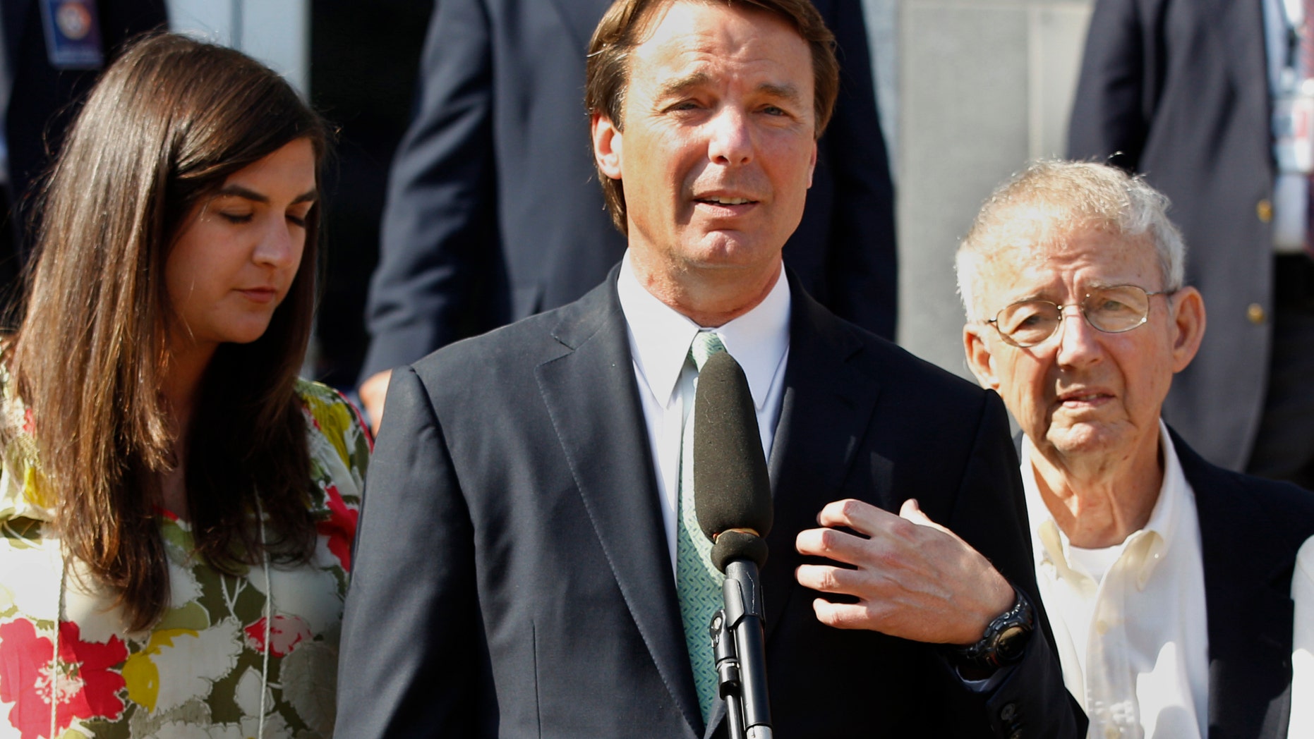 May 31, 2012: Former presidential candidate John Edwards speaks outside a federal courthouse as his daughter, Cate Edwards, left, and father Wallace Edwards, listen after his campaign finance fraud case ended in a mistrial, in Greensboro, N.C.