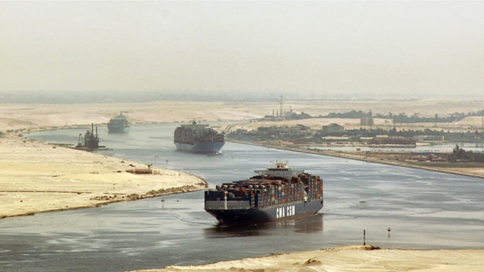 In this Sept. 21, 2009 file photo, cargo ships sail through the Suez Canal, seen from a helicopter, near Ismailia, Egypt. Egypt has agreed to allow two Iranian naval vessels to transit the Suez Canal to the Mediterranean.