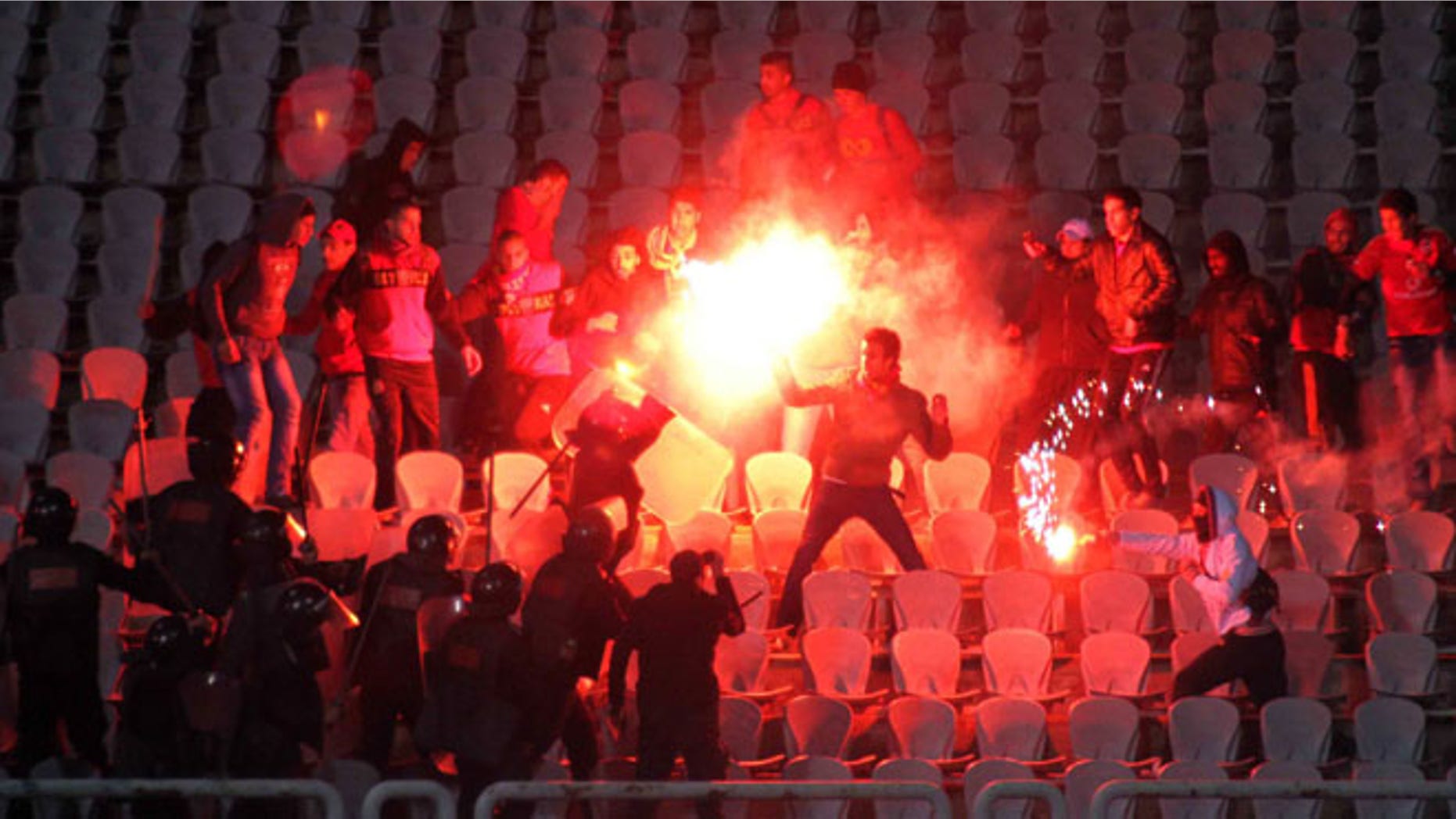 Egyptian fans clash with riot police following Al-Ahly club soccer match against Al-Masry club at the soccer stadium in Port Said, Egypt Wednesday, Feb. 1, 2012. (AP Photo)