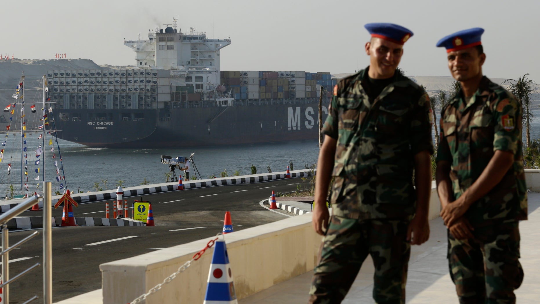 Aug. 6, 2015 - Egyptian army soldiers watch a cargo container ship cross the new section of the Suez Canal after the opening ceremony in Ismailia, Egypt. President Abdel-Fattah el-Sissi, has billed the canal extension as an historic achievement needed to boost the country's ailing economy.