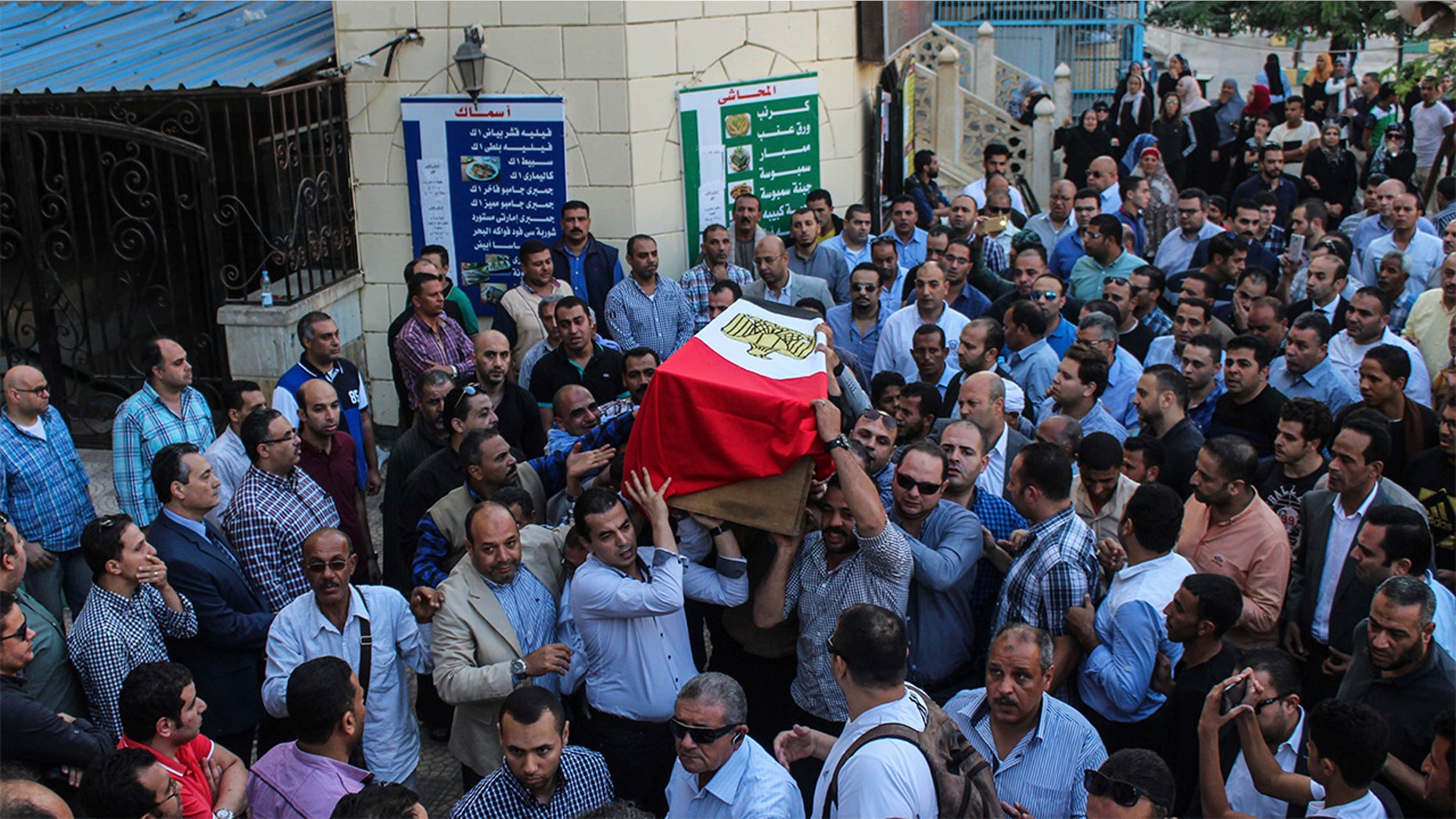 People carry the coffin of Egyptian police officer, Ahmed Fayez who killed a day earlier in a shoot-out with suspected militants south-west of Cairo, during his funeral procession at El Hosary Mosque in Sixth of October city, 15km from Cairo, Egypt.