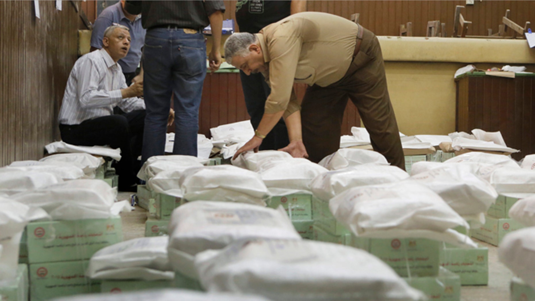 May 25, 2014: An Egyptian worker arranges boxes of ballots at the Giza courthouse a day before the country's two-day presidential elections begins, in Cairo, Egypt. (AP)