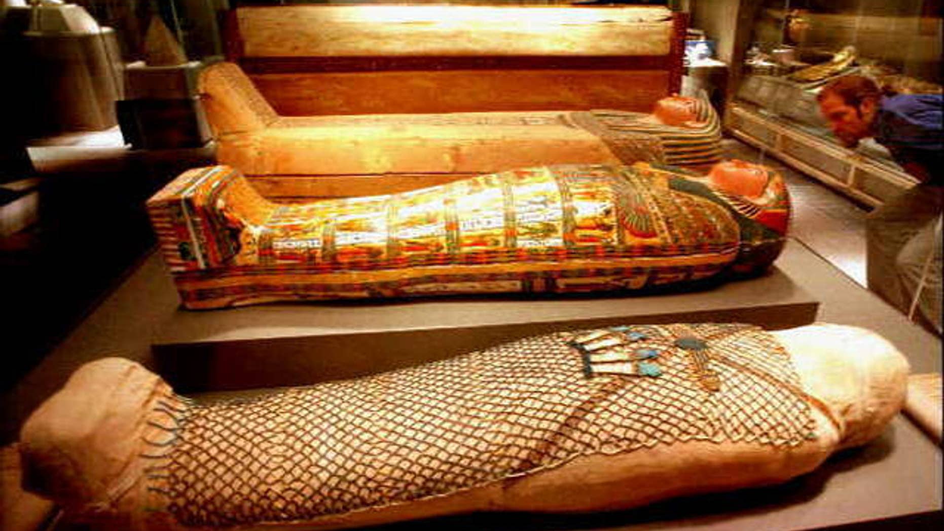 An Egyptian mummy shown in three stages (AP)