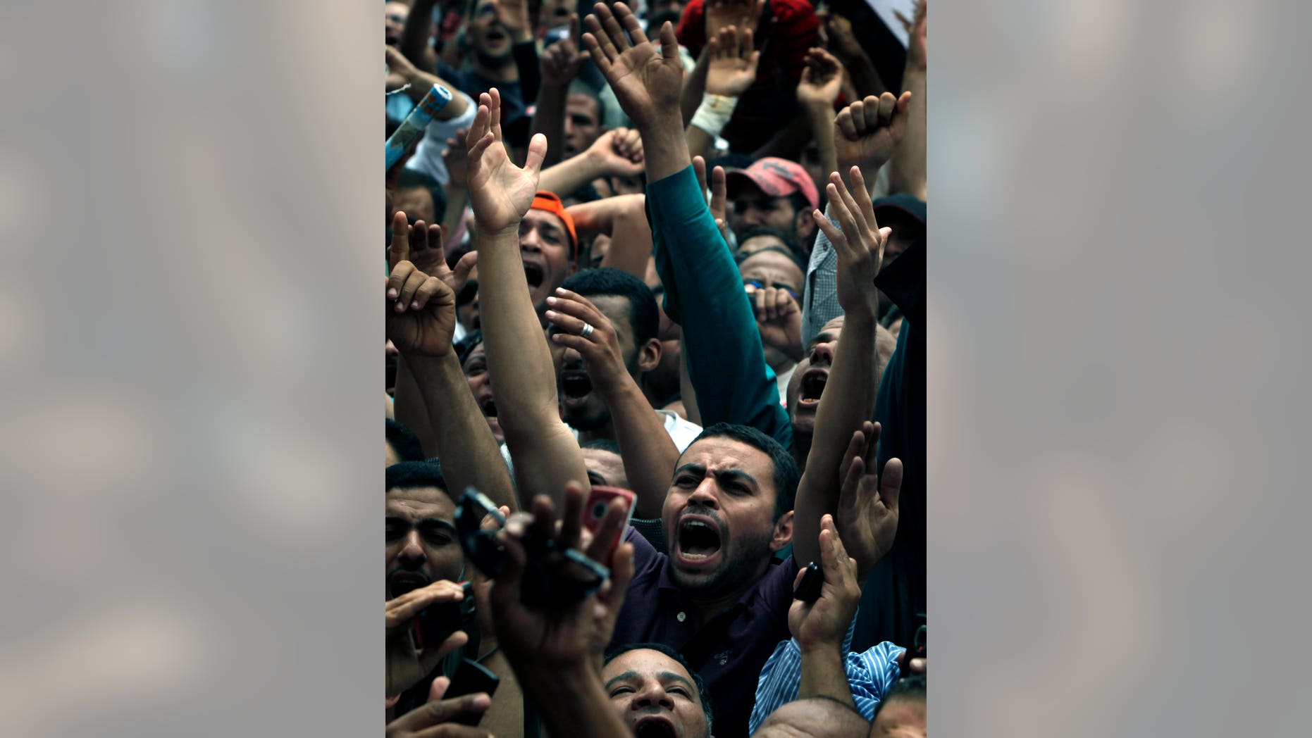 Egyptian protesters chant slogans during a protest at Tahrir Square in Cairo, Egypt ,Friday, May 27, 2011. Thousands of protesters poured into downtown Cairo's Tahrir Square Friday for what they called a "second revolution," striking harsh tone against Egypt's military rulers, and say "Egyptians' revolution is not over."