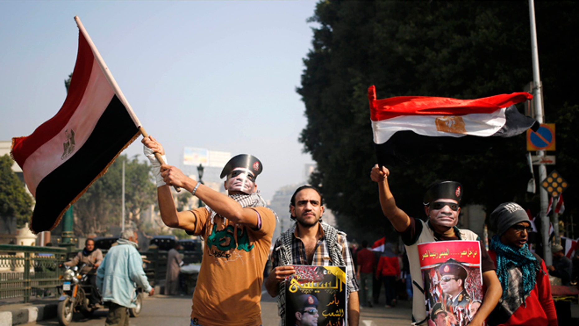 Saturday, Jan. 25, 2014: Egyptians wear masks of Defense Minister Gen. Abdel-Fattah el-Sissi, in Tahrir Square, in Cairo, Egypt.