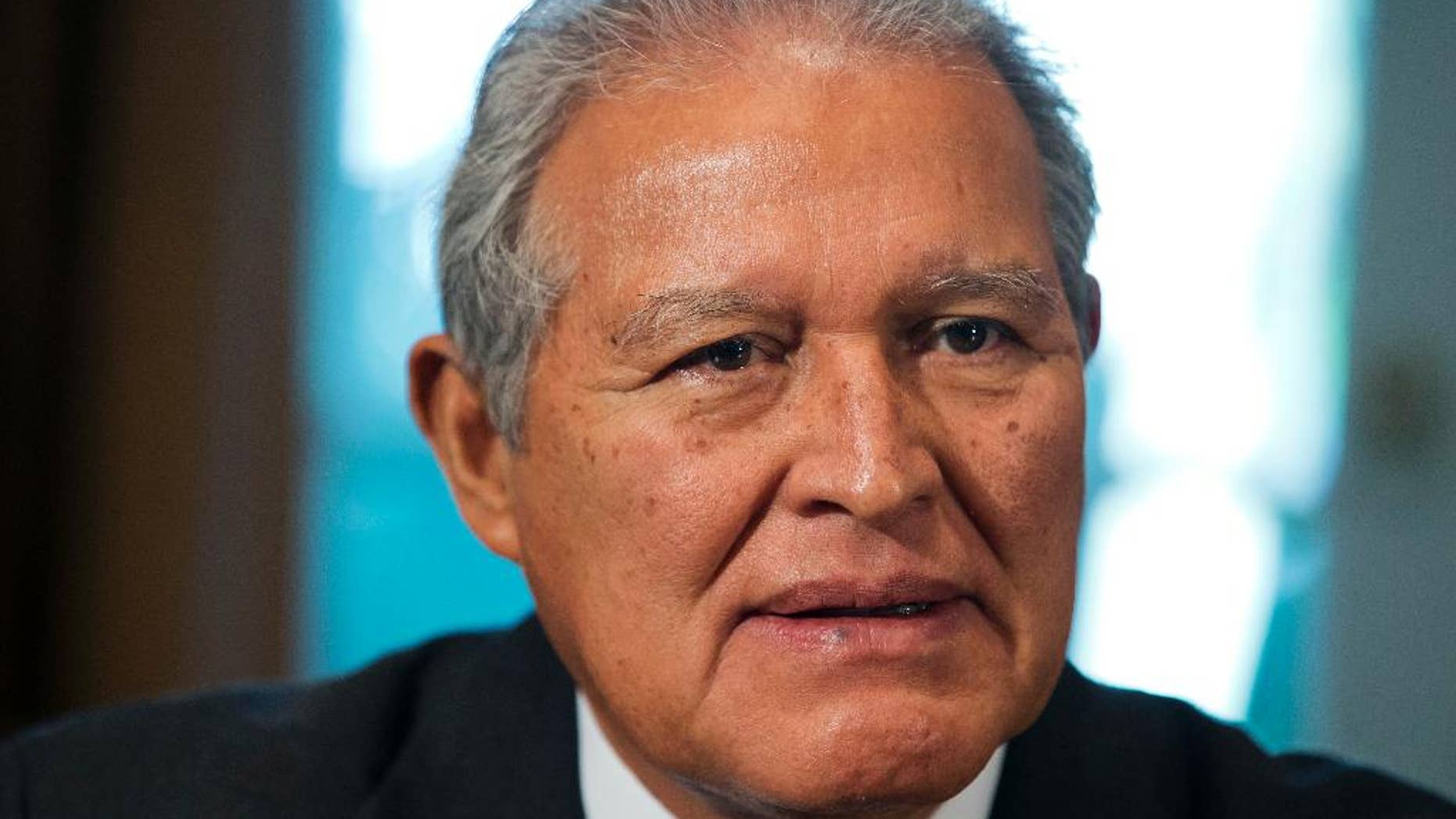 FILE - In this July 25, 2014 file photo, El Salvador's President Salvador Sanchez Ceren, listens as U.S. President Barack Obama speaks to the media, in the Cabinet Room of the White House, in Washington. Ceren on Saturday, Aug. 29, 2015, praised a local Supreme Court ruling declaring the gangs known as maras terrorists. ìNow the persecution of crime will be more effective, the gangs now are terrorists and all the force of the law will be applied against them.î He said it would also make it easier to prosecute those who collaborate with the gangs. (AP Photo/File)