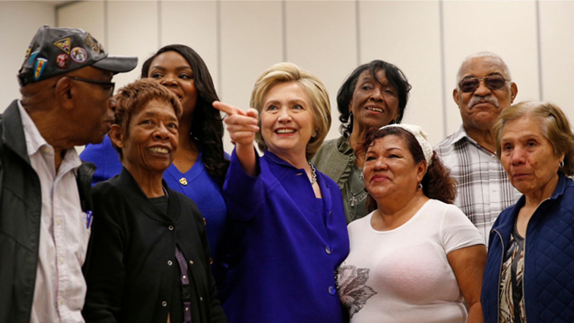 FILE - In this Monday, June 6, 2016 file photo, Democratic presidential candidate Hillary Clinton, center, visits a community center, Monday, June 6, 2016, in Compton, Calif. State officials are preparing to embrace an expanded California electorate Tuesday as nearly 18 million registered voters head for the polls or turn in early presidential primary ballots. (AP Photo/John Locher, File)