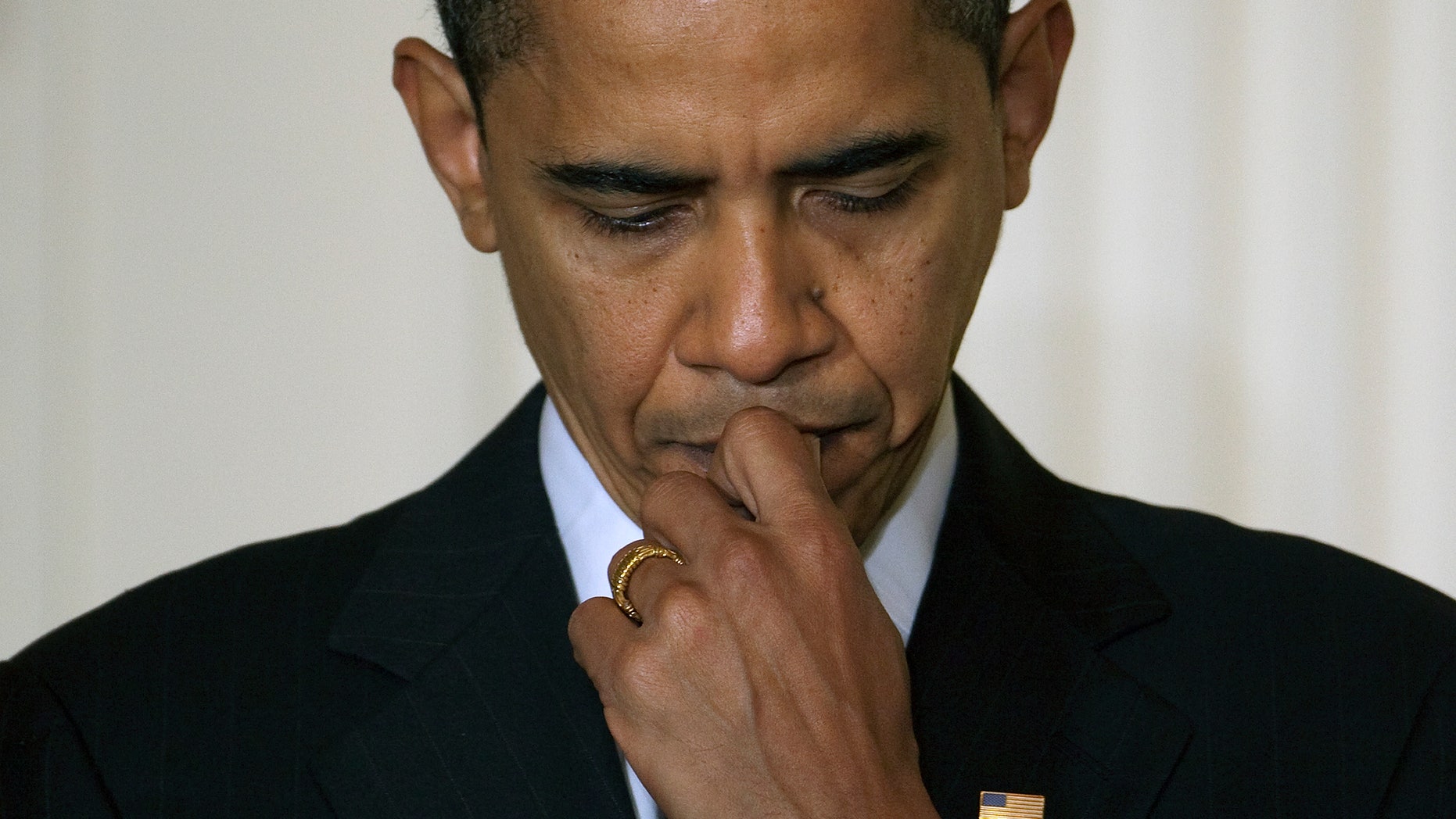 FILE -In this Friday, Feb. 20, 2009, file photo, President Barack Obama listens as Vice President Joe Biden speaks in the East Room of the White House. Asked to name the one step they'd push most urgently if they were the newly re-elected President Barack Obama, a dozen leading economists advise President Barack Obama to sidestep the "fiscal cliff" during his second term of office. Economists say that the package of tax increases and deep spending cuts that will take effect in January unless Congress reaches a budget deal by then, could tip the U.S. economy back into recession next year. (AP Photo/Ron Edmonds, File)