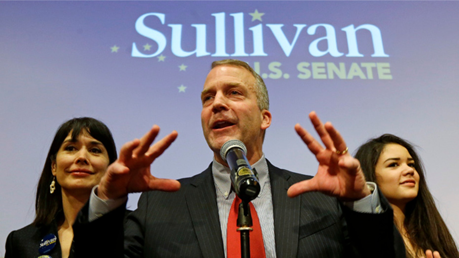 November 4, 2014: Alaska Republican U.S. Senate candidate Dan Sullivan, center, greets supporters in Anchorage. At left is Sullivan's wife Julie, and at right is his daughter Meghan. (AP Photo/Ted S. Warren)