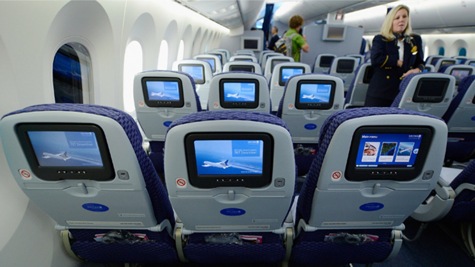 United Airlines flight attendant Tina looks at personal entertainment systems on the new Boeing 787 Dreamliner during a tour of the jet at Los Angeles International Airport on November 30, 2012 in Los Angeles, California. (Photo by Kevork Djansezian/Getty Images)