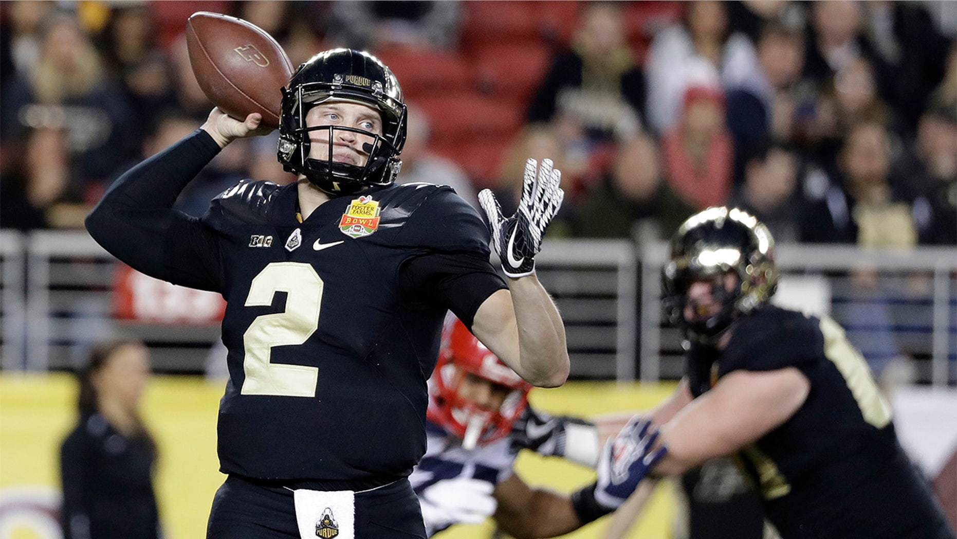 Purdue quarterback Elijah Sindelar, left, throws against Arizona during the first half of the Foster Farms Bowl NCAA college football game Wednesday, Dec. 27, 2017, in Santa Clara, Calif. (AP Photo/Marcio Jose Sanchez)
