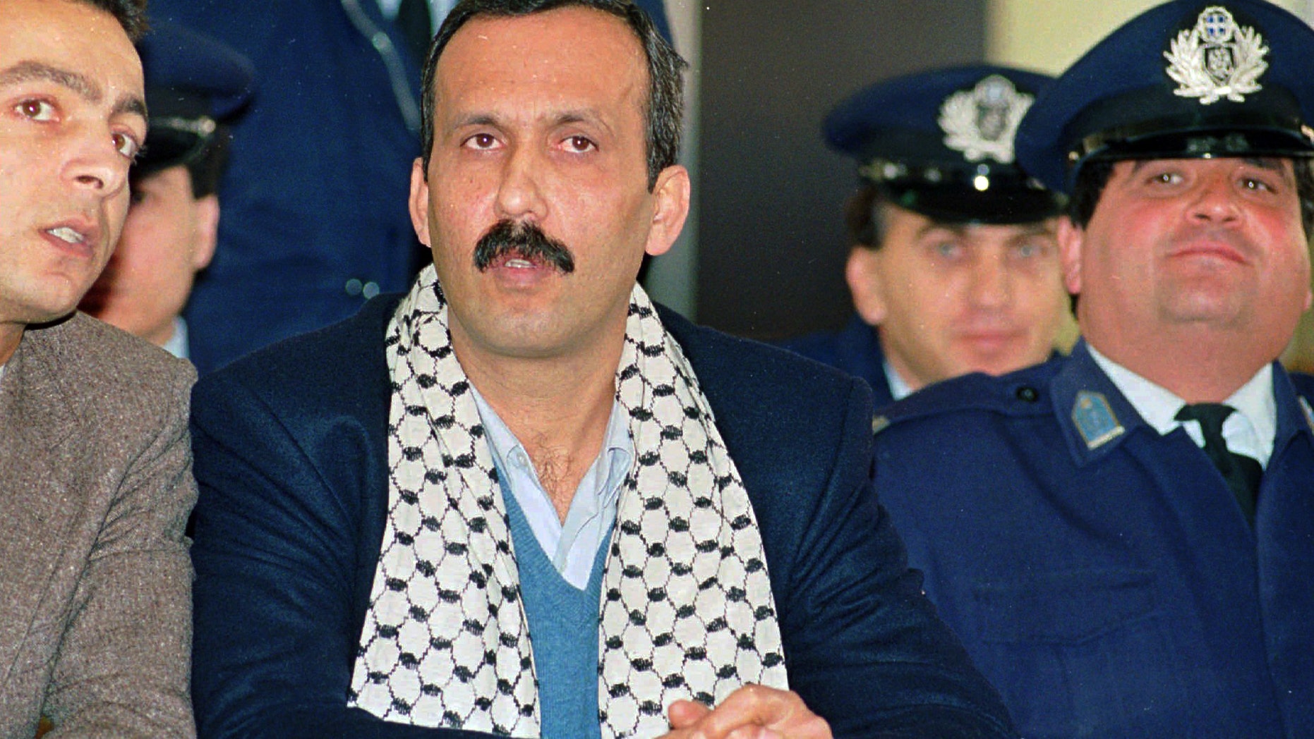 In this December 12, 1991, file photo Mohammed Rashed, center, convicted of the 1982 PanAm jetliner bombing, listens to his unidentified PLO interpreter, left, during his appeals court hearing in Athens, Greece.