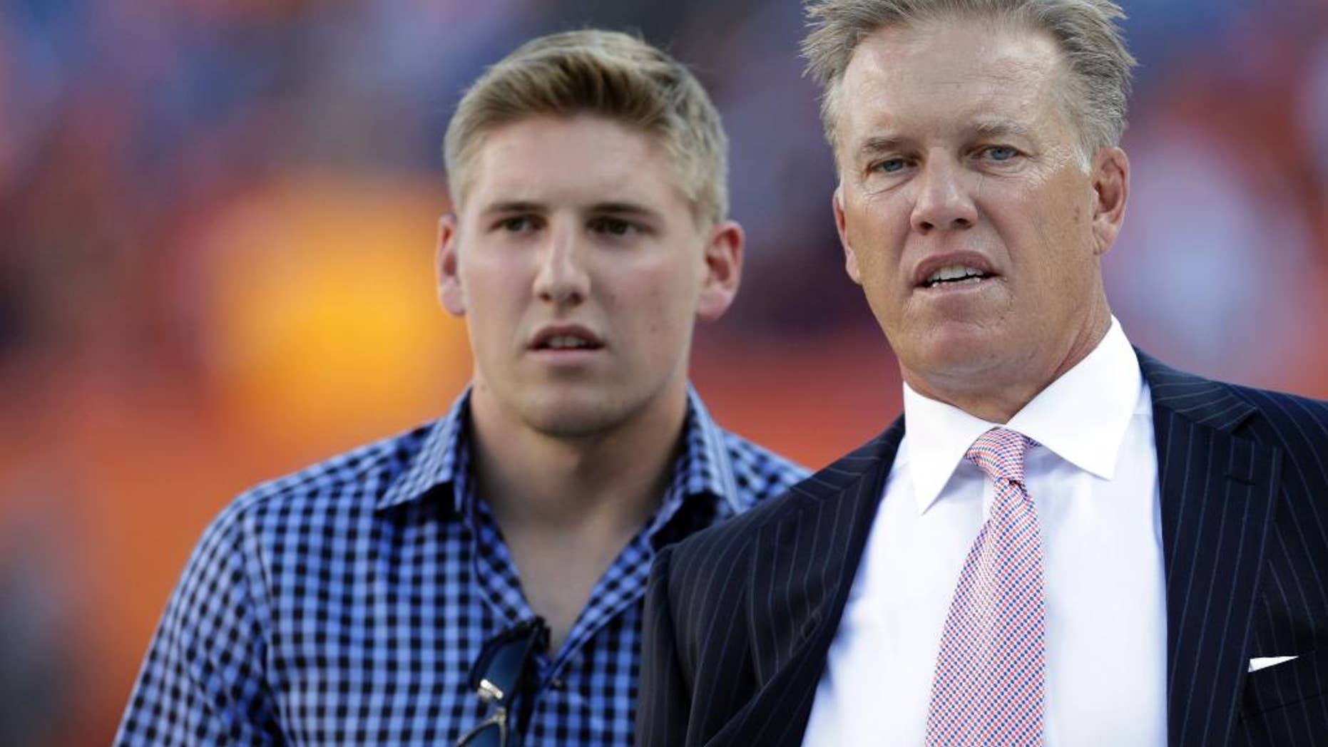 FILE - This Sept. 9, 2012 file photo shows John Elway and his son, Jack Elway at Mile High Stadium, in Denver. Jack Elway, was arrested Saturday May 31, 2014 in Denver, on charges of assault and disturbing the peace. (AP Photo/Joe Mahoney, file)