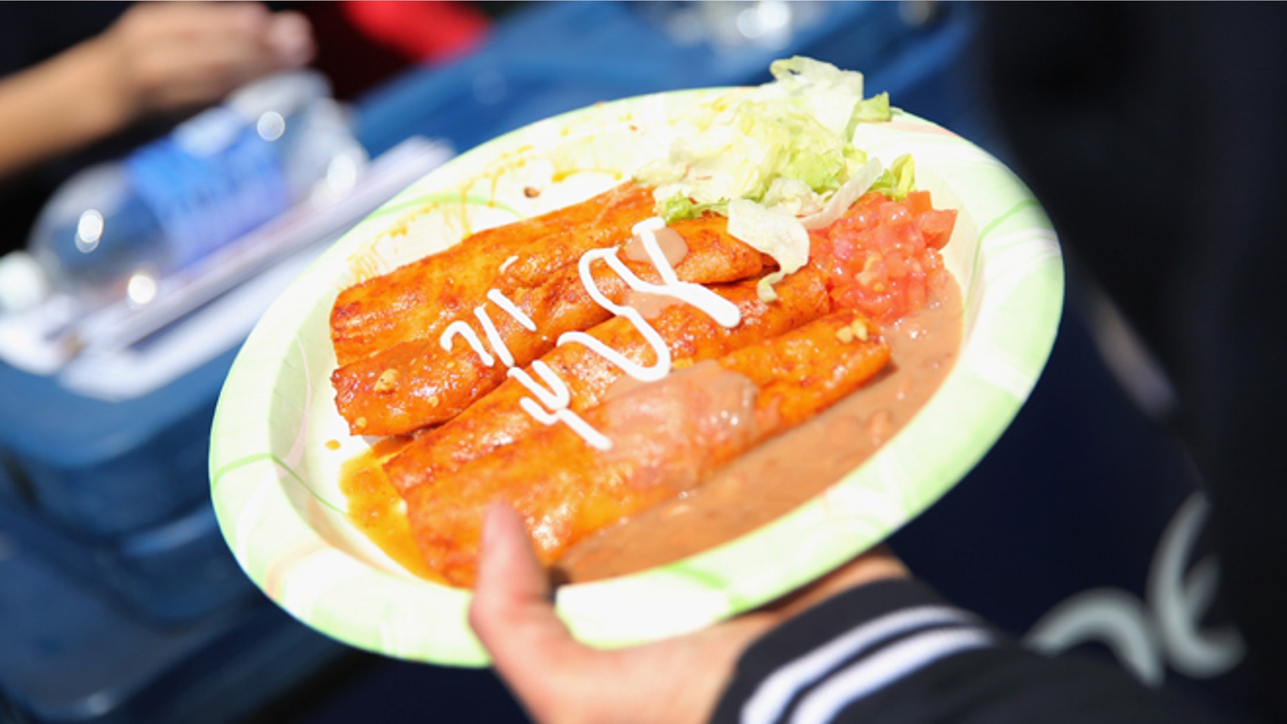 DENVER, CO - MAY 04: A plate of enchiladas is carried through a Cinco de Mayo festival on May 4, 2013 in Denver, Colorado. Hundreds of thousands of people were expected to attend the two day event, billed as the largest Cinco de Mayo celebration in the United States. Cinco de Mayo observes the victory of the Mexican army over French forces on May 5, 1862 in the town of Puebla, Mexico. The festival celebrates Mexican culture and is one of the most popular annual Latino events in the United States. (Photo by John Moore/Getty Images)