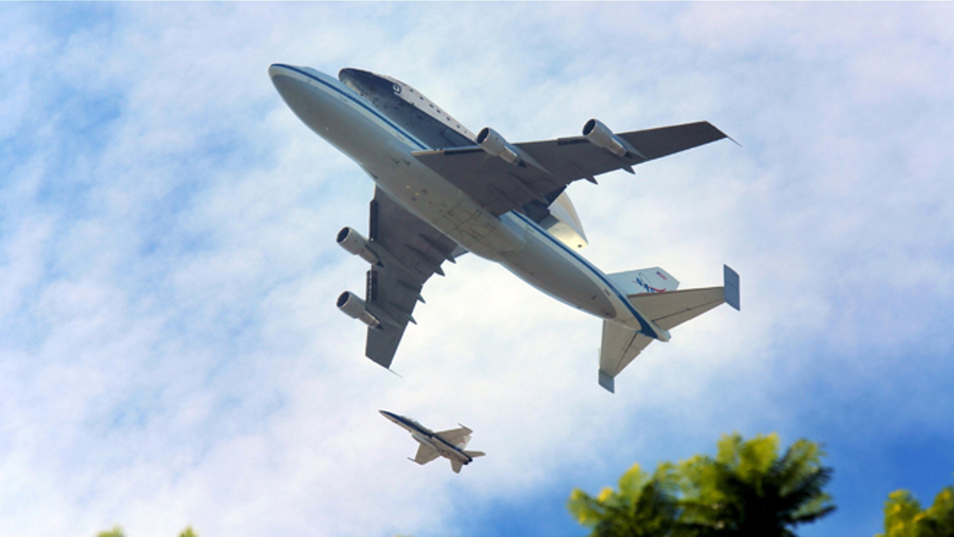 LOS ANGELES, CA - SEPTEMBER 21: The space shuttle Endeavour, on top of NASA's Shuttle Carrier Aircraft or SCA, flies over Los Angeles on September 21, 2012 in Los Angeles, California. The space shuttle Endeavour did a 4-1/2 hour tour over California landmarks before heading to Los Angeles International Airport where it will be prepared to be moved to its new permanent home at the California Science Center in downtown Los Angeles. The shuttle will be on public display starting October 30. (Photo by Sandy Huffaker/Getty Images)