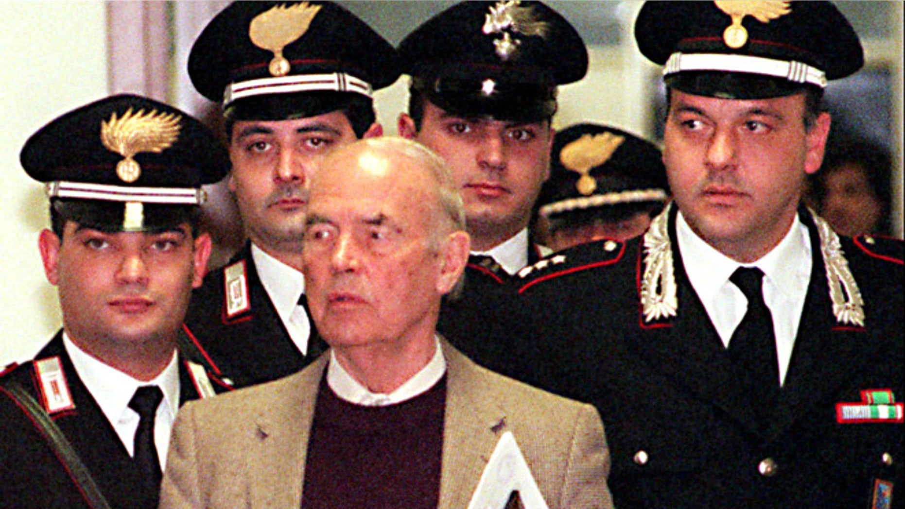 In this Thursday, Dec. 7, 1995 file photo, Former Nazi SS officer Erich Priebke enters the military court in Rome. Priebke, a former Nazi SS captain, was sentenced to life in prison for his role in one of the worst atrocities by German occupiers in Italy during World War II. In 1994, Priebke was extradited to Italy from Argentina and put on trial for his role in the 1944 massacre outside Rome. Nazi forces killed 335 civilians to avenge an attack by resistance fighters that killed 33 members of a Nazi military police unit a day earlier. Priebke admitted shooting two people and rounding up victims, but insisted he was only following orders.