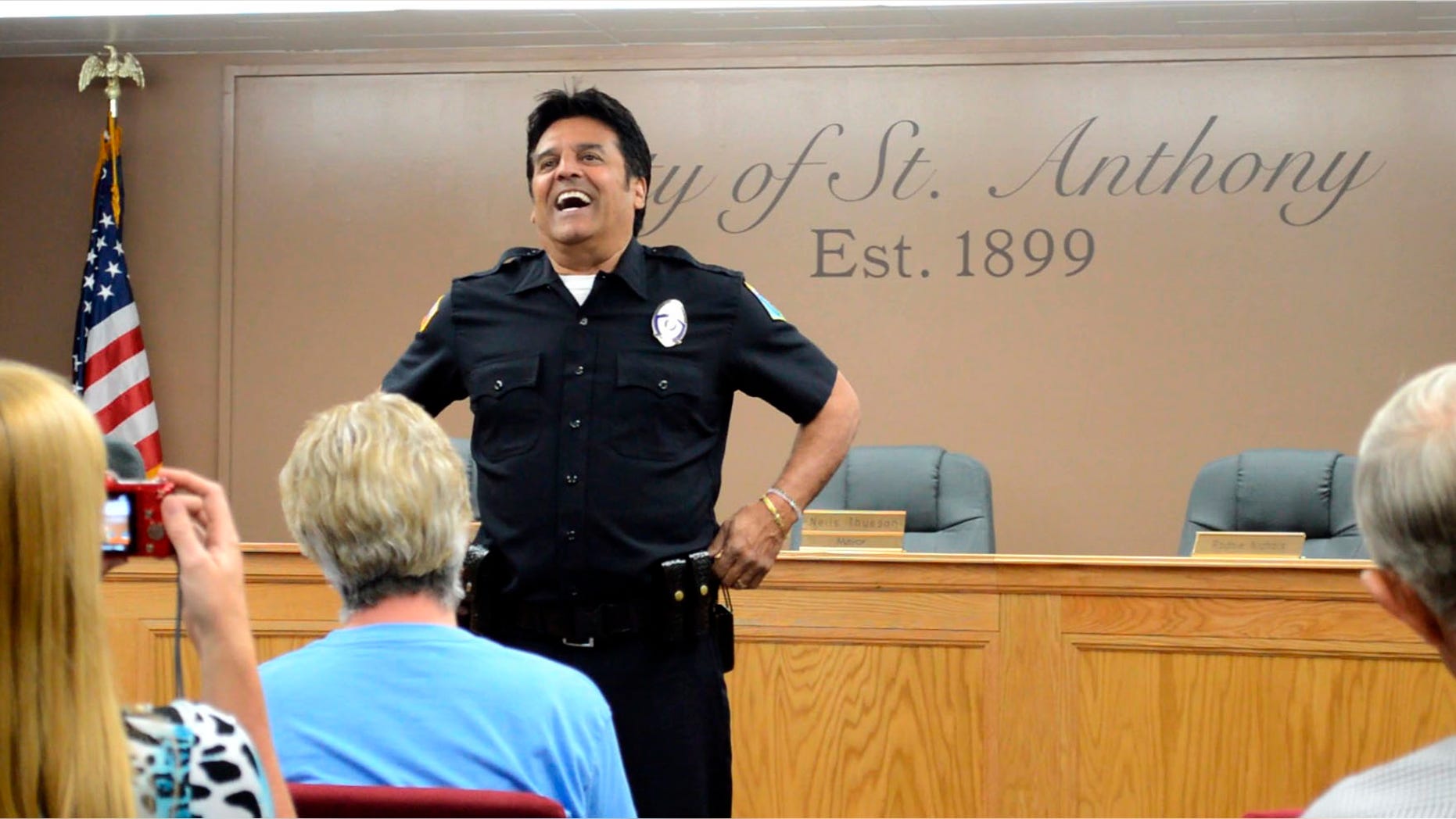 In this Saturday, July 2, 2016, photo famed "CHiPs" police officer Erik Estrada mets St. Anthony residents to discuss his efforts with the St. Anthony Police Department to stop internet enticement of children at St. Anthony City Hall. Estrada has spent the past decade working with various law enforcement departments to keep kids safe online. Following his induction Estrada as a now a St. Anthony Police Department reserve officer, he told how important it is to teach children what not to do while on the web. (Lisa Dayley-Smith/Rexburg Standard Journal via AP) MANDATORY CREDIT