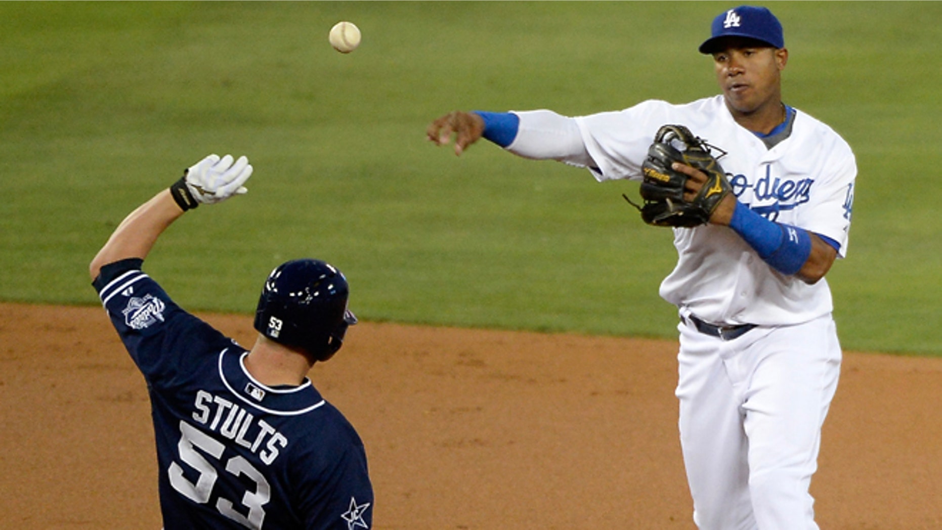 LOS ANGELES, CA - AUGUST 20: Erisbel Arruebarrena #11 of the Los Angeles Dodgers makes a throw to complete a double play in front of Eric Stults #53 of the San Diego Padres during the second inning at Dodger Stadium on August 20, 2014 in Los Angeles, California. (Photo by Harry How/Getty Images)