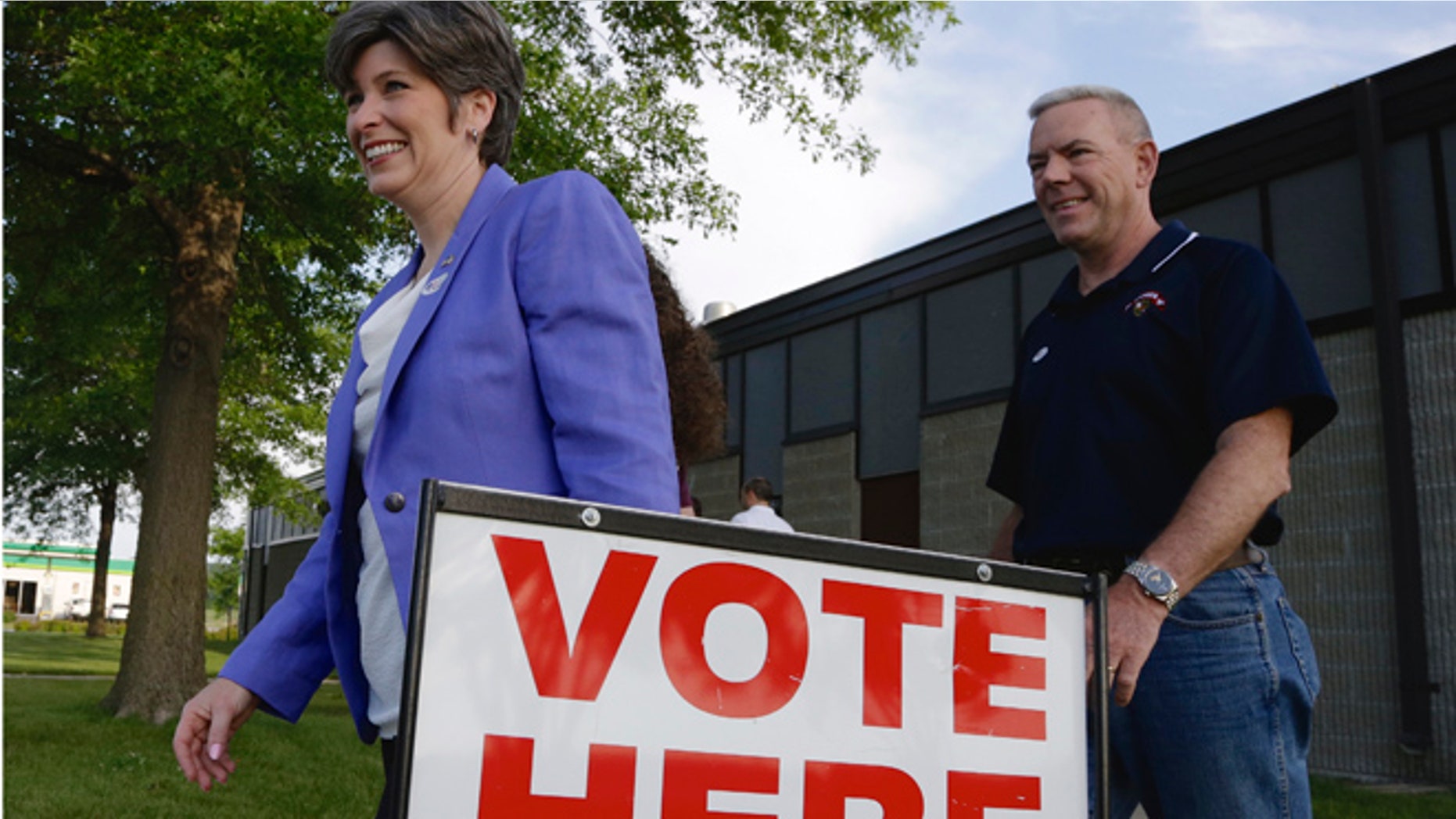 June 3, 2014: GOP Senate candidate Joni Ernst and husband Gail, right, leave a polling station in Red Oak, Iowa.