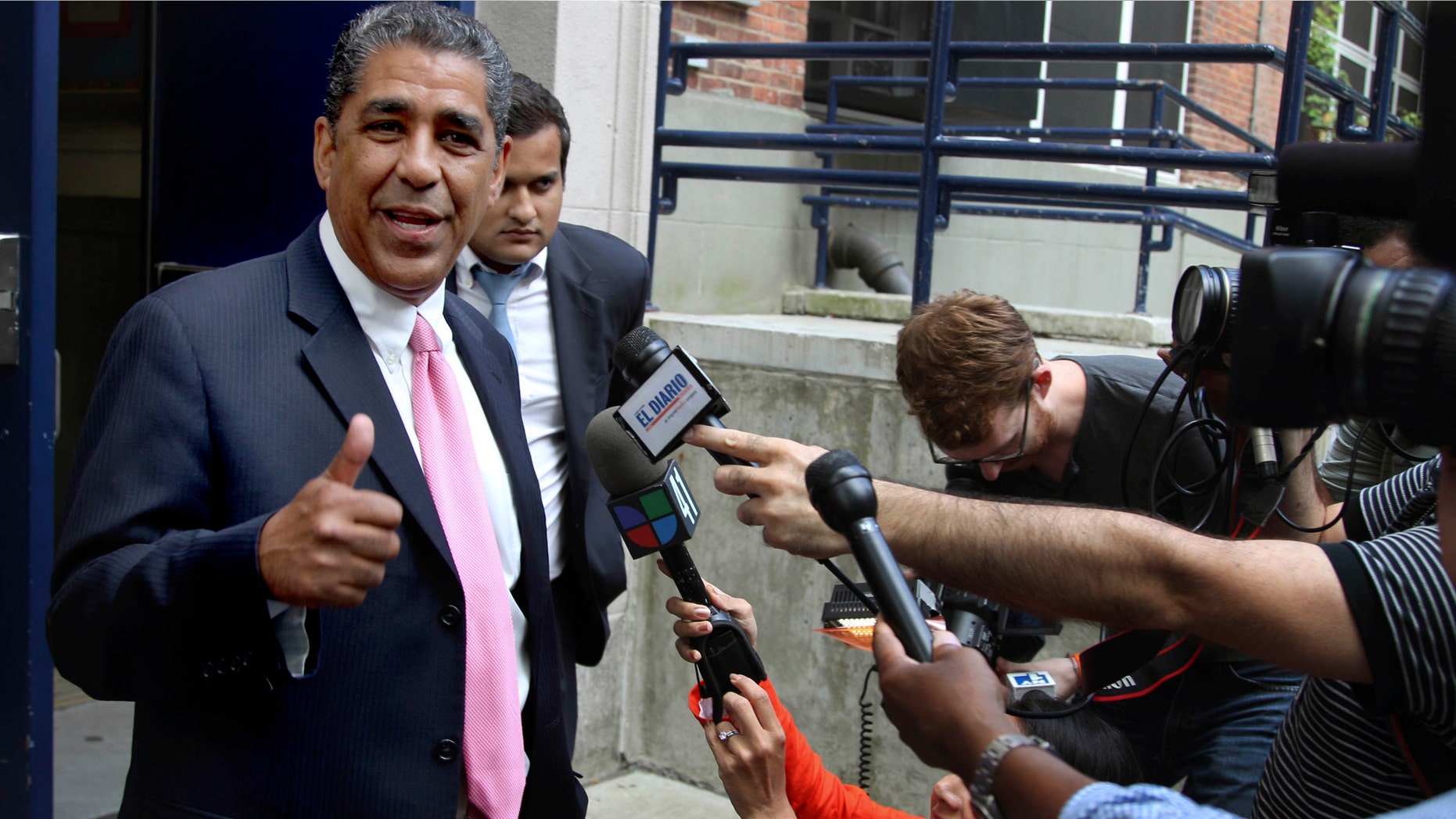 New York State Senator Adriano Espaillat talks to the media after voting in the Democratic congressional primary in New York, Tuesday, June 26, 2012. Candidates running for the House of Representatives will find out Tuesday what kind of support they have among New York voters. Espaillat is running against Rep. Charles Rangel. (AP Photo/Seth Wenig)