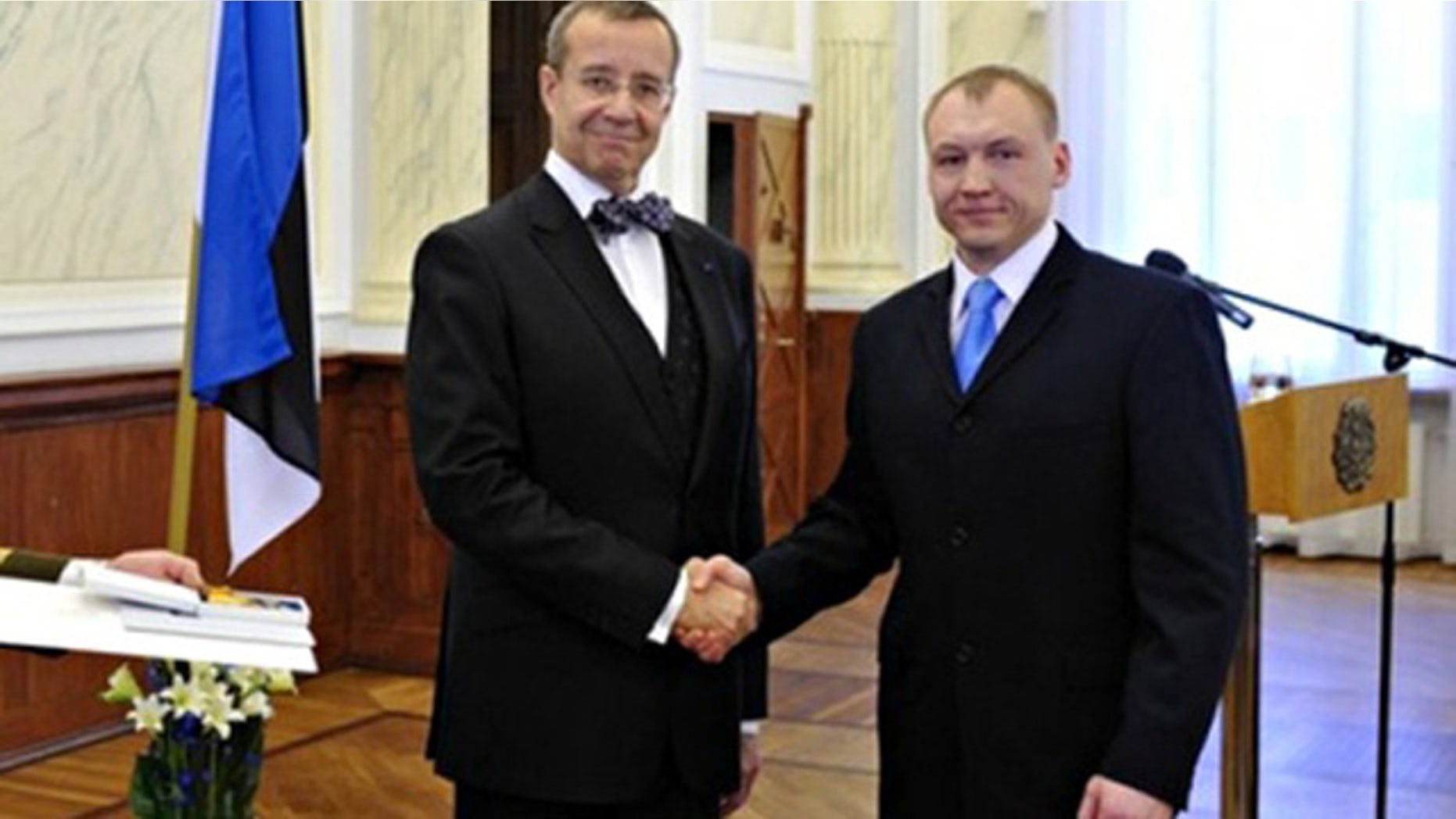 This 2010 photo shows Eston Kohver, right, receivning a decoration from Estonia's President Toomas Hendrik.