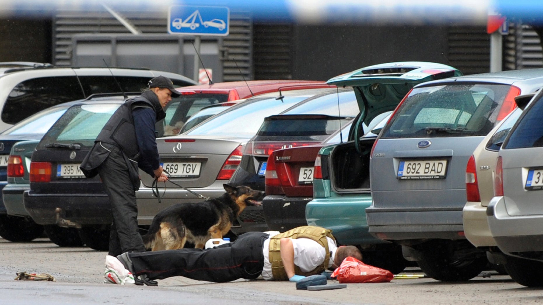 August 11:Estonian police officers check the area for explosives near the Defense Ministry building in Tallinn, Estonia. A gunman opened fire inside the building as he tried to take hostages but he apparently was shot and killed by police. The attacker entered the ministry at midday, threw a smoke bomb, fired shots and tried to kidnap two employees.