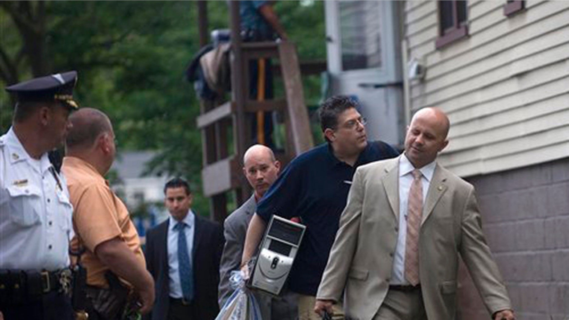 June 6, 2012: New York City police detectives carry out items from the home of Pedro Hernandez in Maple Shade, N.J.