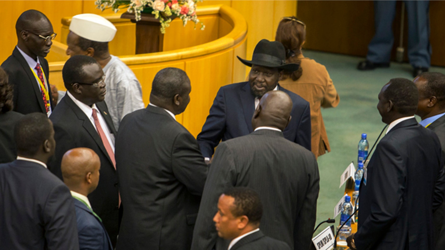 Aug. 17, 2015: South Sudan's rebel leader Riek Machar, center-left with back to camera, shakes hands with South Sudan's President Salva Kiir, center-right wearing a black hat, after lengthy peace negotiations in Addis Ababa, Ethiopia. Kiir refused to sign a peace agreement Monday with rebel forces, saying he needs 15 days before he will sign, although Machar had signed the accord before Kiir refused. (AP Photo/Mulugeta Ayene)