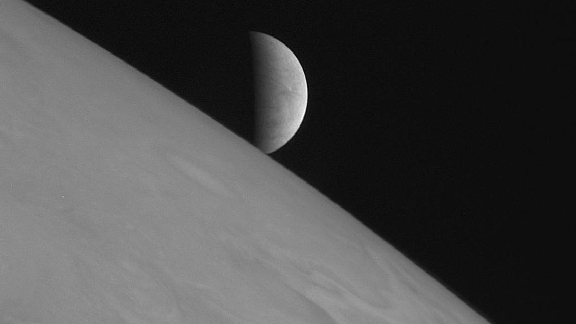 New Horizons took this image of the icy moon Europa rising above Jupiter's cloud tops after the spacecraft's closest approach to Jupiter.