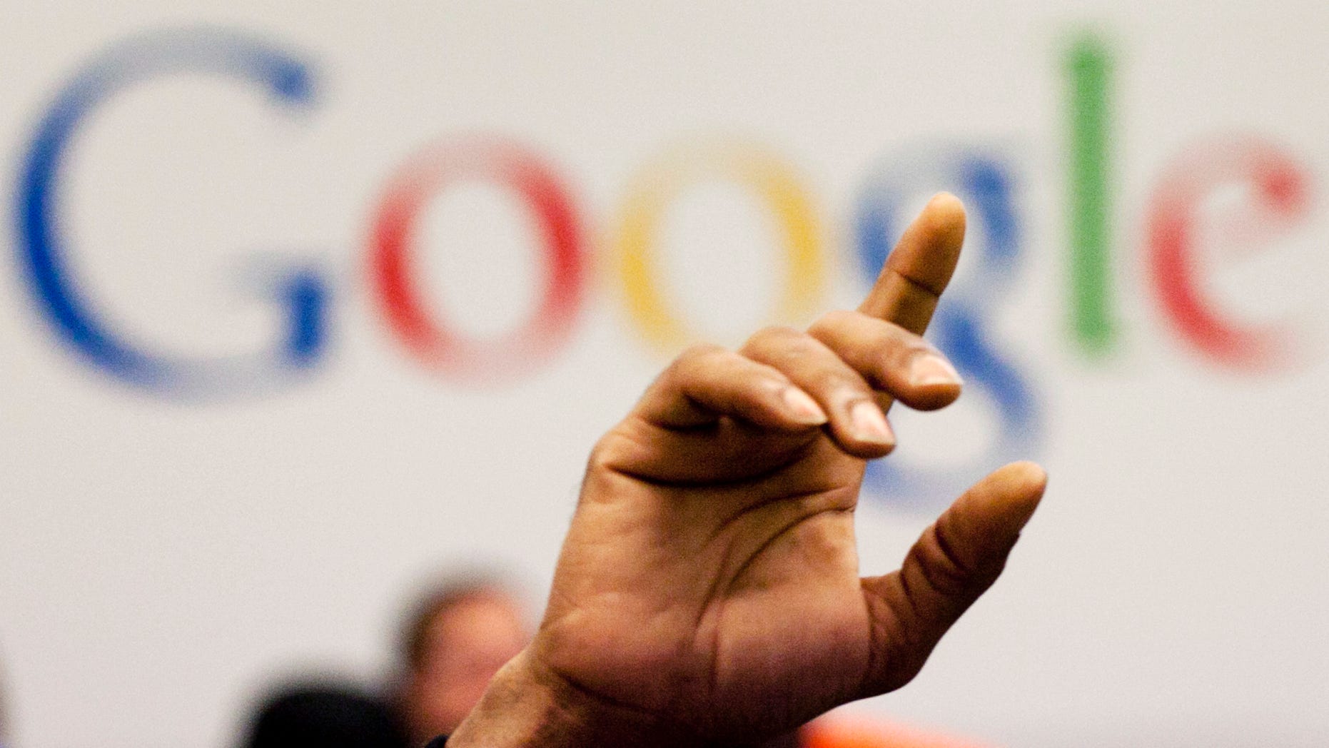 FILE - In this Oct. 17, 2012, file photo, a man raises his hand during at Google offices in New York. People should have some say over the results that pop up when they conduct a search of their own name online, Europe's highest court said Tuesday, May 13, 2014. (AP Photo/Mark Lennihan, File)