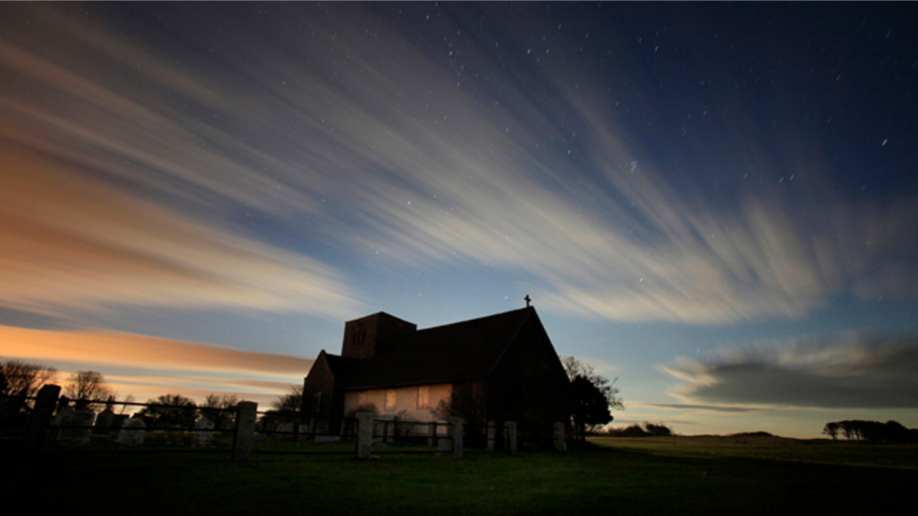 In this two-minute exposure, the rising moon illuminates clouds sweeping across the evening sky over St. Martin's In The Field, an Episcopal summer chapel in Biddeford Pool, Maine. With the winter solstice, Maine now receives only about nine hours of daylight.
