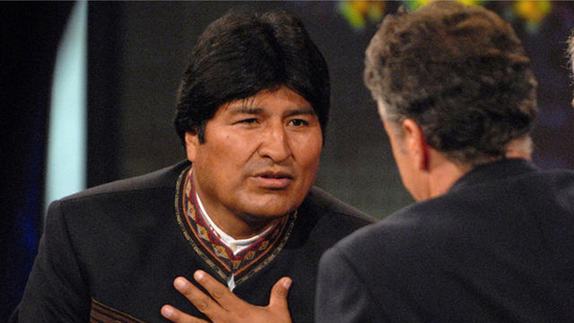 Bolivian President Evo Morales, left, speaks with Daily Show host Jon Stewart, center, on Comedy Central's "The Daily Show with Jon Stewart" in New York, Tuesday Sept. 25, 2007. Morales's translator is seen at right. (AP Photo/Peter Kramer)