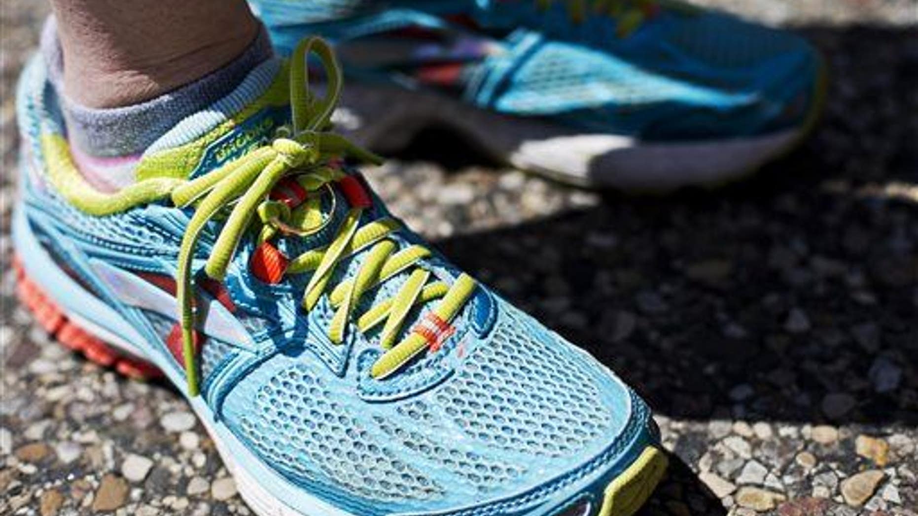 Grandville resident Stephanie Systema completes the the 2014 Fifth Third River Bank Run 25K in Grand Rapids, Mich., Saturday, May 10, 2014, with the wedding ring of her late husband Paul tied to her shoe. Sytsema ran the 25K in memory of Paul, whose goal was to complete a full marathon. (AP Photo/The Grand Rapids Press, Andrew Kuhn)