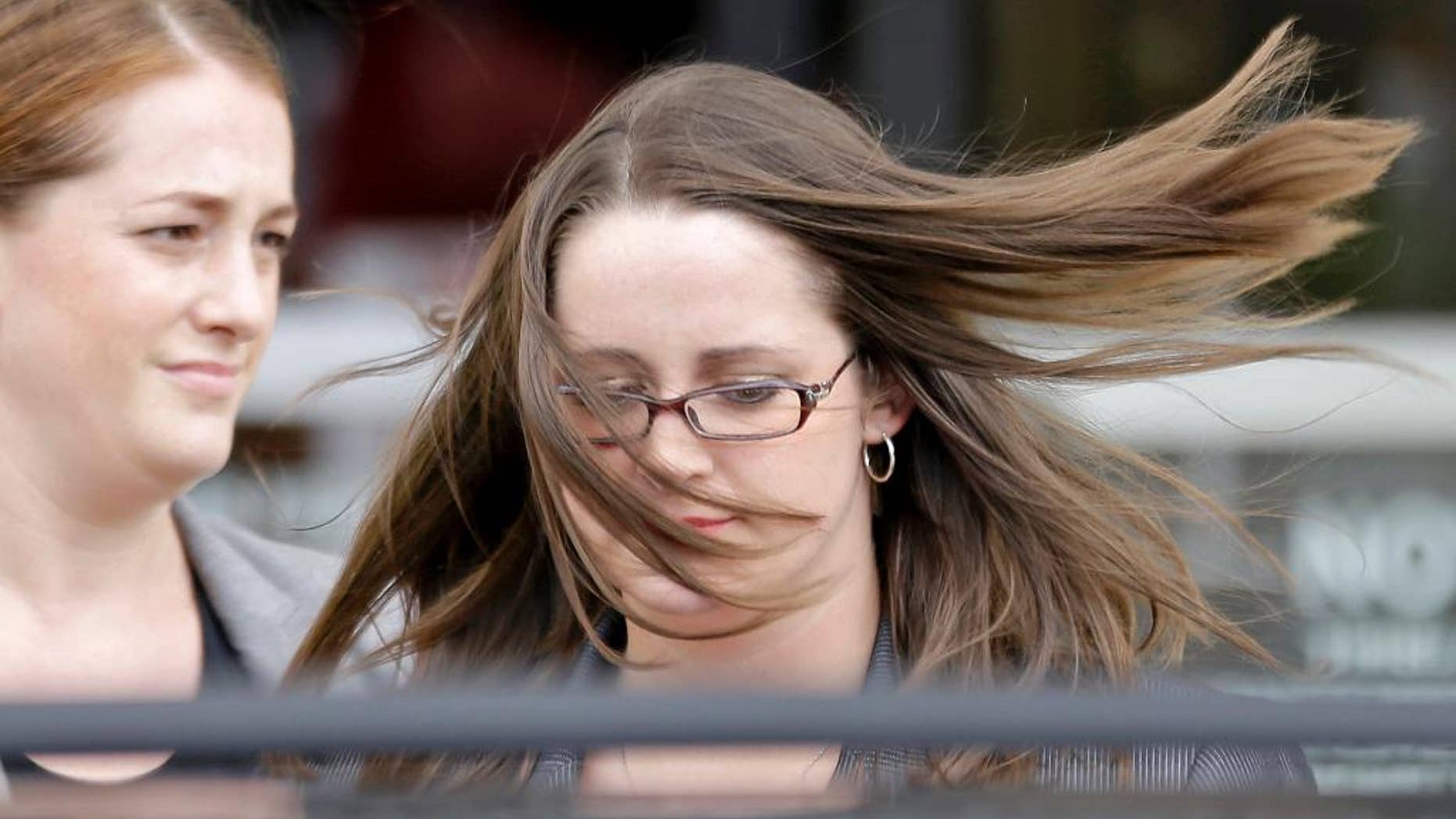FILE - In this Tuesday, July 23, 2013 file photo, Celia Savage, right, gets into a waiting car as she leaves federal court after pleading guilty to two federal firearms charges in Gainesville, Ga. Savage, 25, appeared Friday, Oct. 31, 2014, before a judge who sentenced her to serve three years in prison. (AP Photo/David Goldman, File)