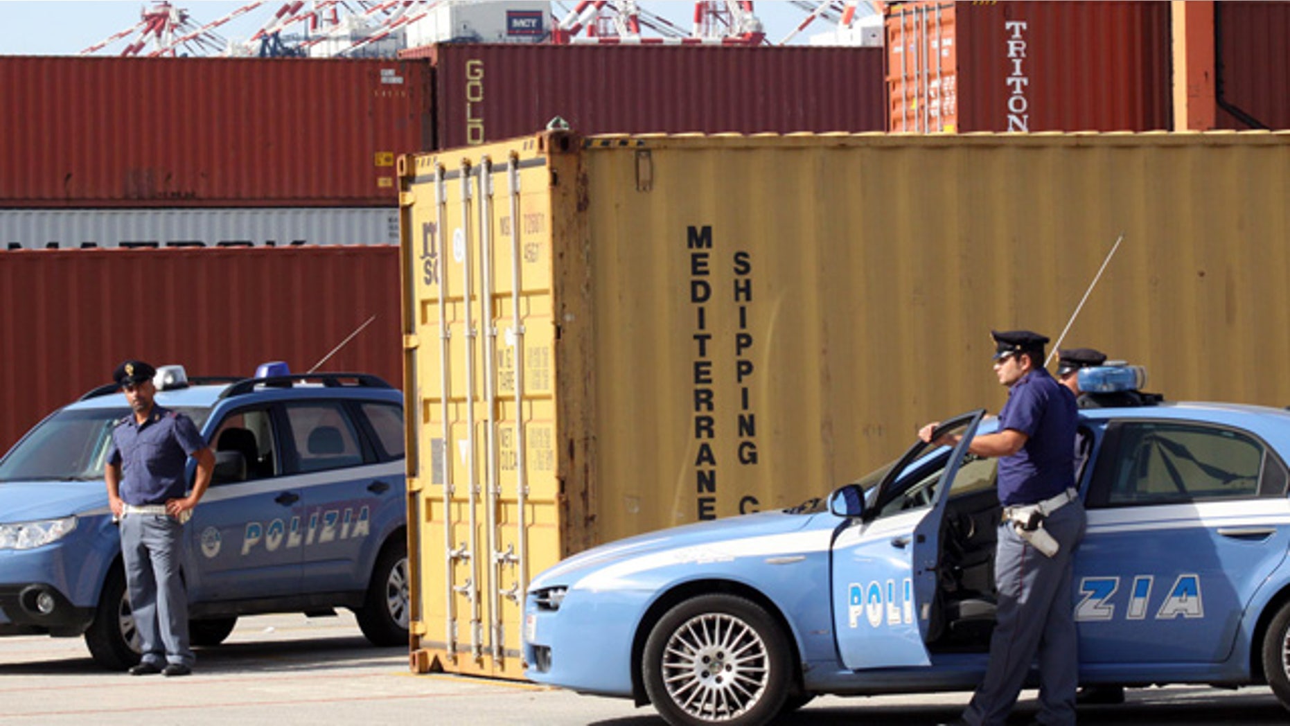 Italian police stand guard by a confiscated container, in the port of Gioia Tauro, near Reggio Calabria, southern Italy, on Wednesday, Sept. 22, 2010. Police officials say they have seized a "huge'' shipment of powerful RDX explosives that may have originated in Iran. Reggio Calabria police chief Carmelo Casabona told an Italian private television news that the amount was too large to be destined only to the Calabrian mob. (AP Photo/Adriana Sapone)