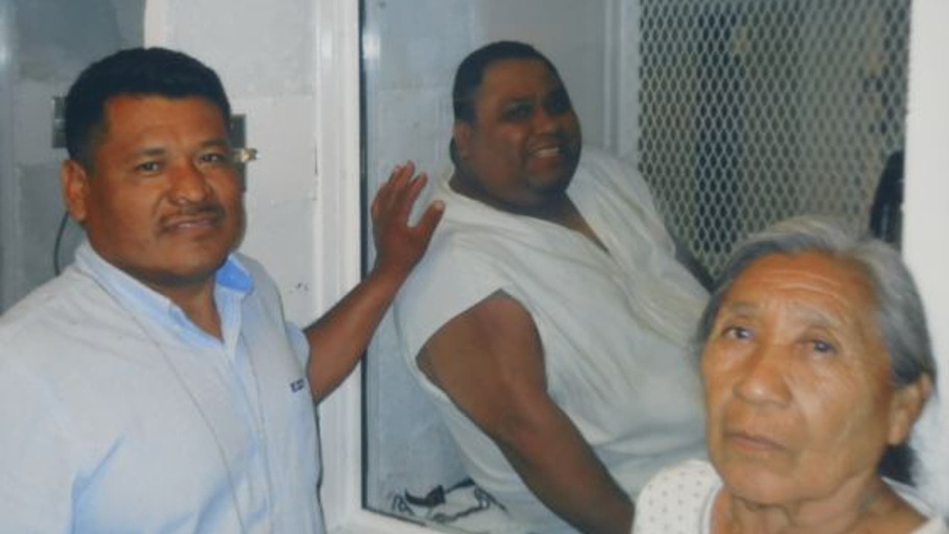 Ramiro Hernandez Llanas, center, with members of his family.