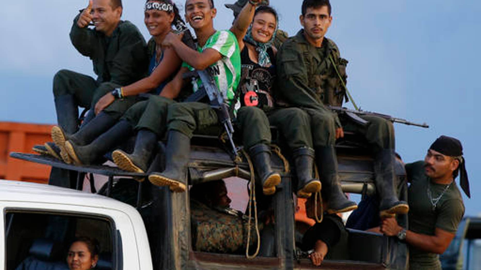 Rebels of the Revolutionary Armed Forces of Colombia (FARC) arrive to El Diamante in southern Colombia, Friday, Sept. 16, 2016. FARC rebels are gathering for a congress to discuss and vote on a peace accord reached with the Colombian government to end five decades of war. Historically secretive, this congress is the first one open to civilians. (AP Photo/Ricardo Mazalan)