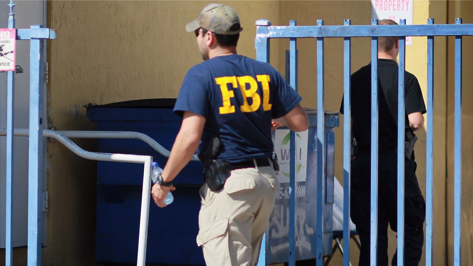 MIAMI - OCTOBER 21: An agent with the F.B.I. is seen outside the American Therapeutic Corp. building on October 21, 2010 in Miami, Florida. Federal agents raided the building this morning during an operation that resulted in the arrest of four in what is being called one of the nation's biggest Medicare fraud cases. They are being charged with scheming to fleece $200 million from the Medicare program by billing for bogus mental health services. (Photo by Joe Raedle/Getty Images)