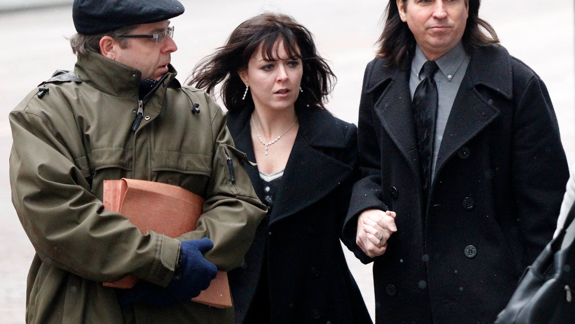 Jan. 6: Shawn Begolly, right, walks to federal court for a detention hearing for his son, Emerson Begolly with his wife, Tiffani, center, and a public defender investigator, in Pittsburgh. Emerson Begolly is being held on charges he bit two FBI agents while carrying a loaded gun on Jan. 4.
