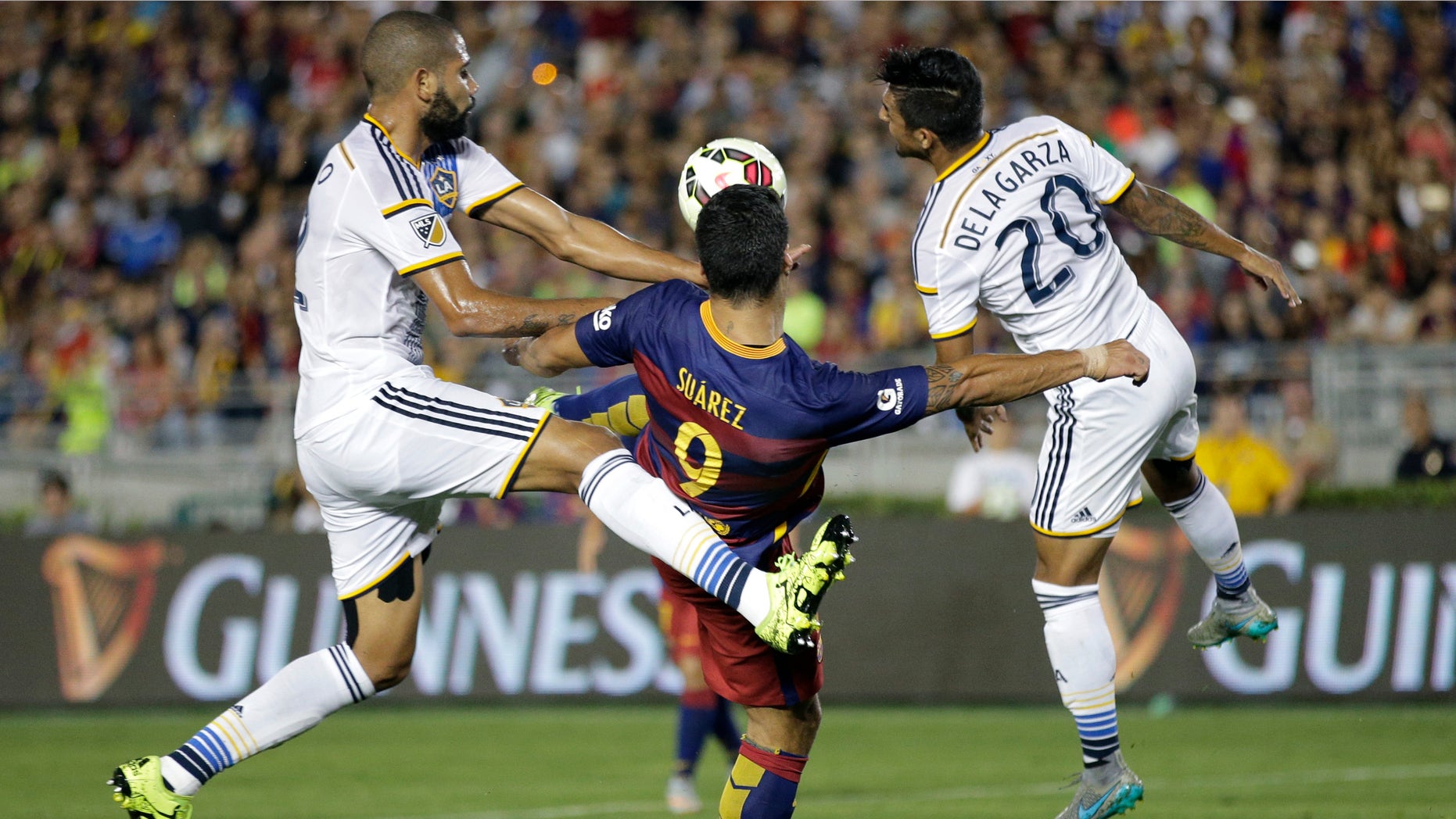 Luis Suarez, center, during the first half of an International Champions Cup soccer match, Tuesday, July 21, 2015.