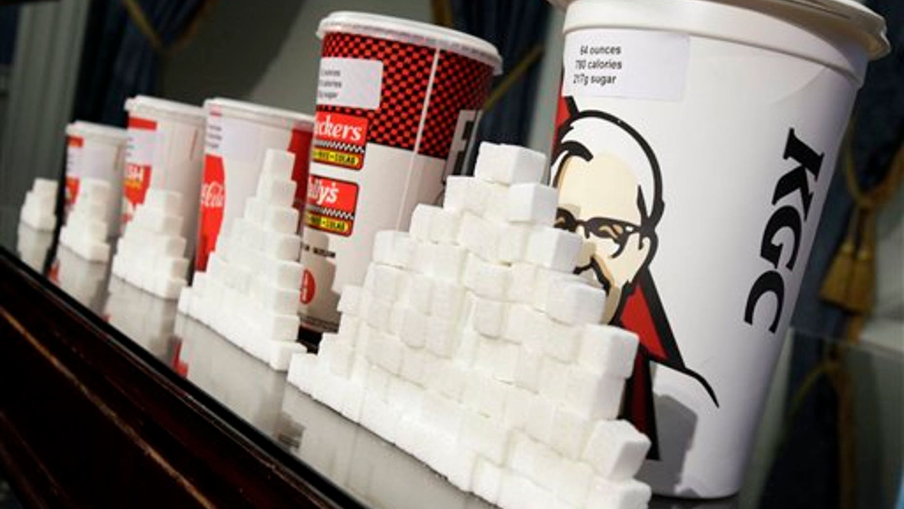 FILE - This May 31, 2012 file photo shows a display of various size soft drink cups next to stacks of sugar cubes at a news conference at New York's City Hall. Its one of our most personal daily decisions: what to eat or drink. Maybe inhale. Does banning trans fat from our food mean the government is getting serious about cracking down on all sorts of other unhealthy stuff: Soda? Salt? Cigarettes? Alcohol? Probably not. In fact, in some states, theyre easing the way for marijuana. (AP Photo/Richard Drew, File)