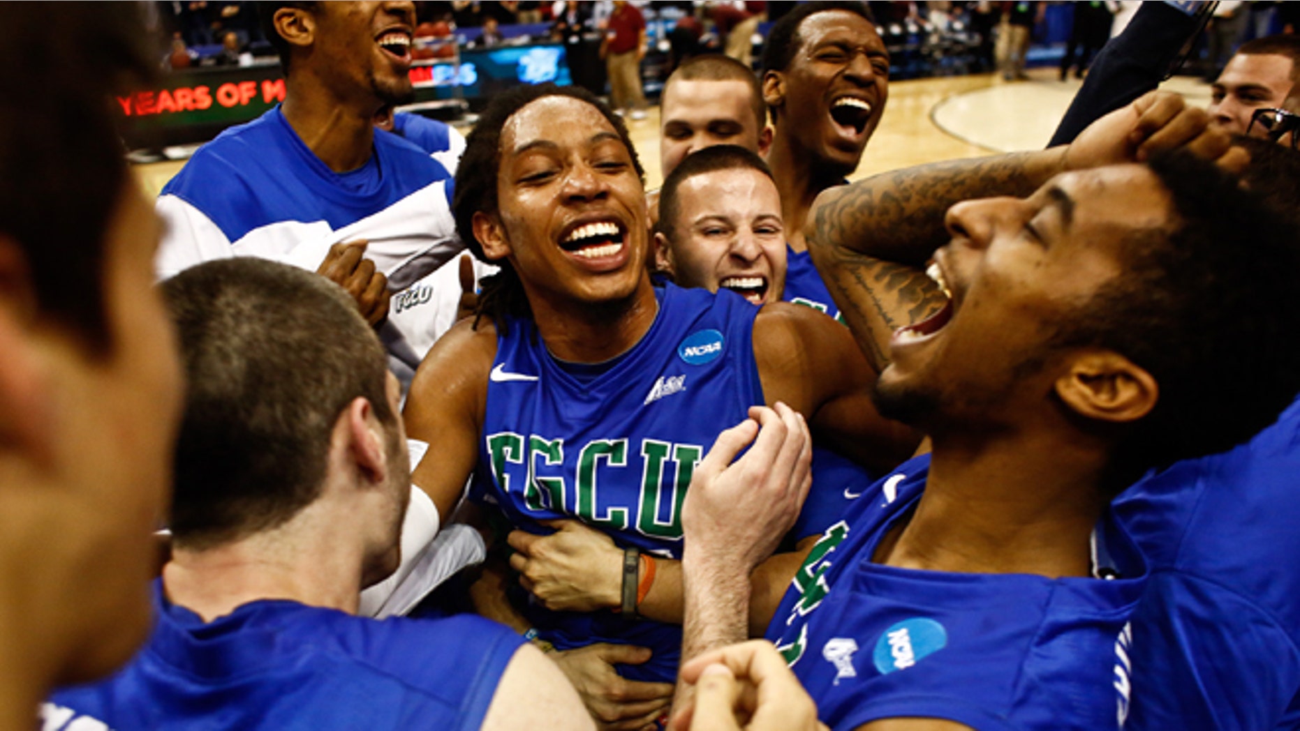 Florida Gulf Coast players celebrate after winning a third-round game against San Diego State in the NCAA college basketball tournament, Sunday, March 24, 2013, in Philadelphia. Florida Gulf Coast won 81-71. (AP Photo/Naples Daily News, Scott McIntyre)