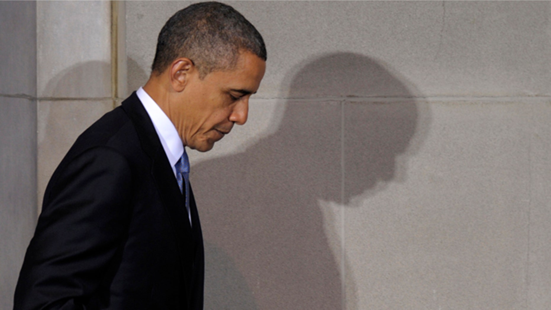 President Barack Obama casts a shadow as he walks off of the stage after speaking at the 2012 Tribal Nations Conference, Wednesday, Dec. 5, 2012, at the Interior Department in Washington. Native American tribal leaders are concerned that steady progress on their issues might be undermined if President Barack Obama and Congress make deep spending cuts to avoid the "fiscal cliff." More than 500 tribal leaders were taking those concerns to the fourth White House Tribal Nations summit, which convenes Wednesday. (AP Photo/Susan Walsh)