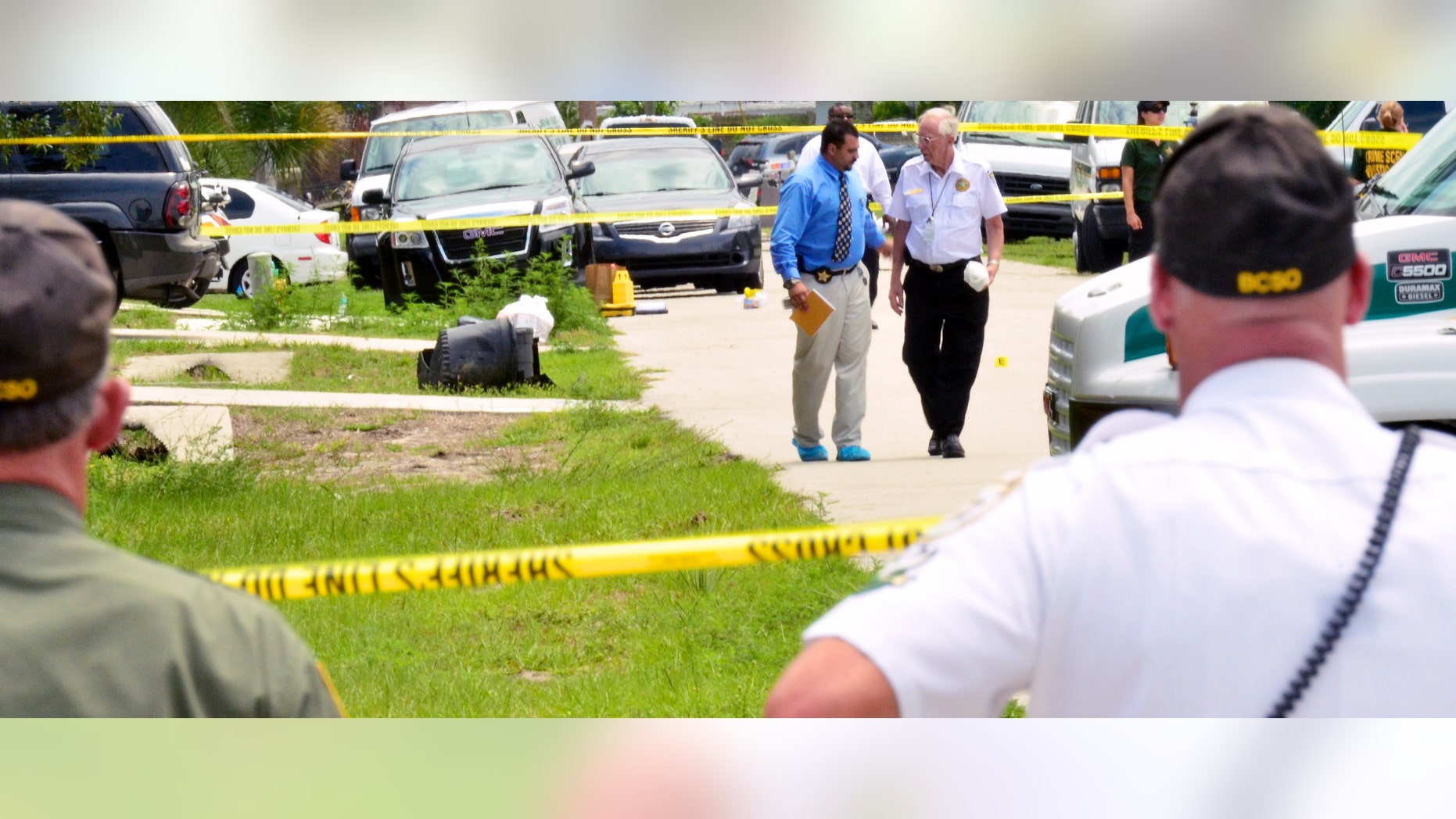 PORT ST JOHN, FL - MAY 15: Brevard County crime scene workers conduct an investigation after Tonya Thomas shot her four children and then herself May 15, 2012 in Port St. John, Florida. The children ranged in ages 12 to 17 and the family had a history of domestic complaints. (Photo by Roberto Gonzalez/Getty Images)