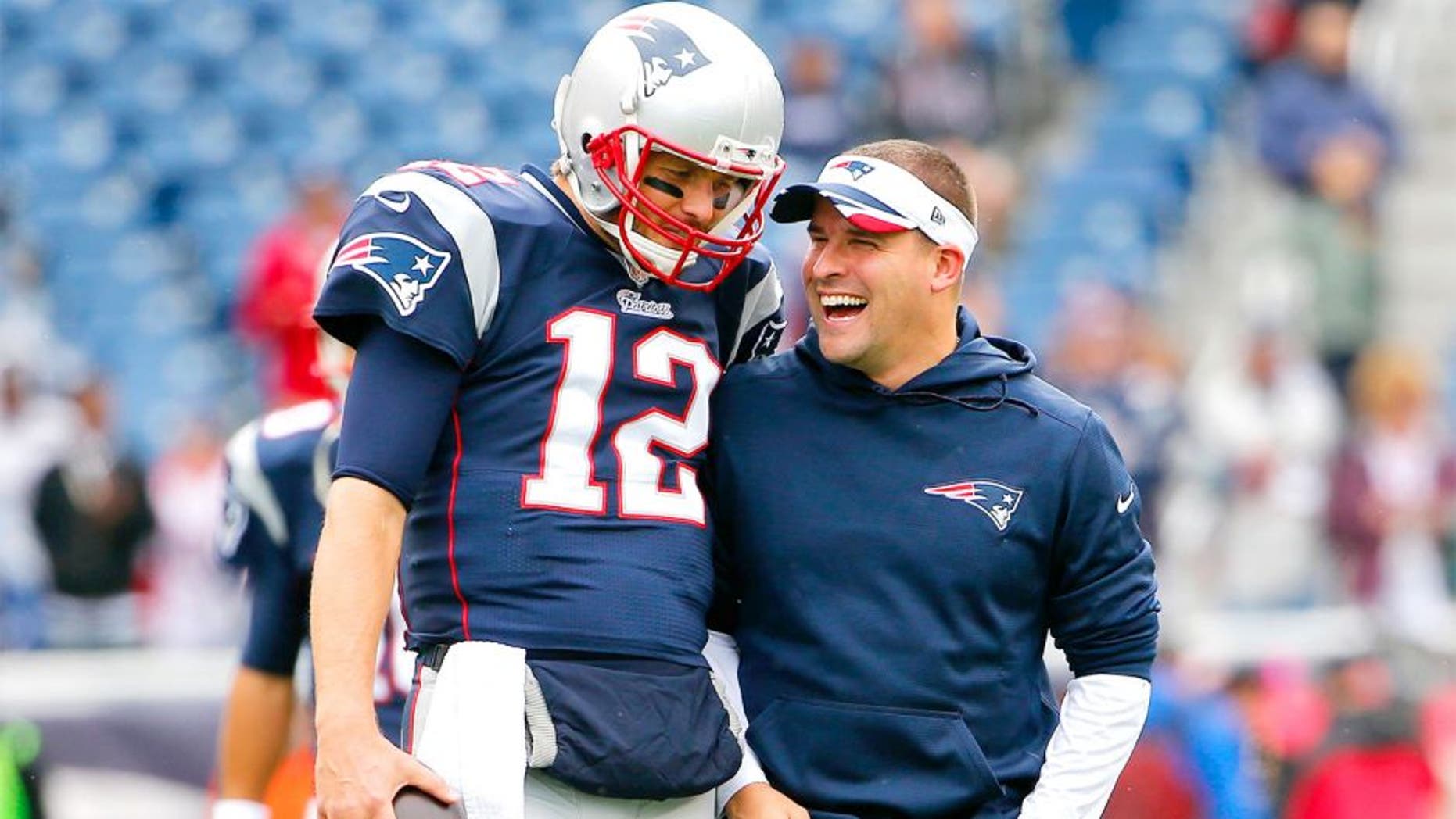 Oct 26, 2014; Foxborough, MA, USA; New England Patriots quarterback Tom Brady has a laugh with offensive coordinator Josh McDaniels before the game between the New England Patriots and the Chicago Bears at Gillette Stadium. Mandatory Credit: Winslow Townson-USA TODAY Sports